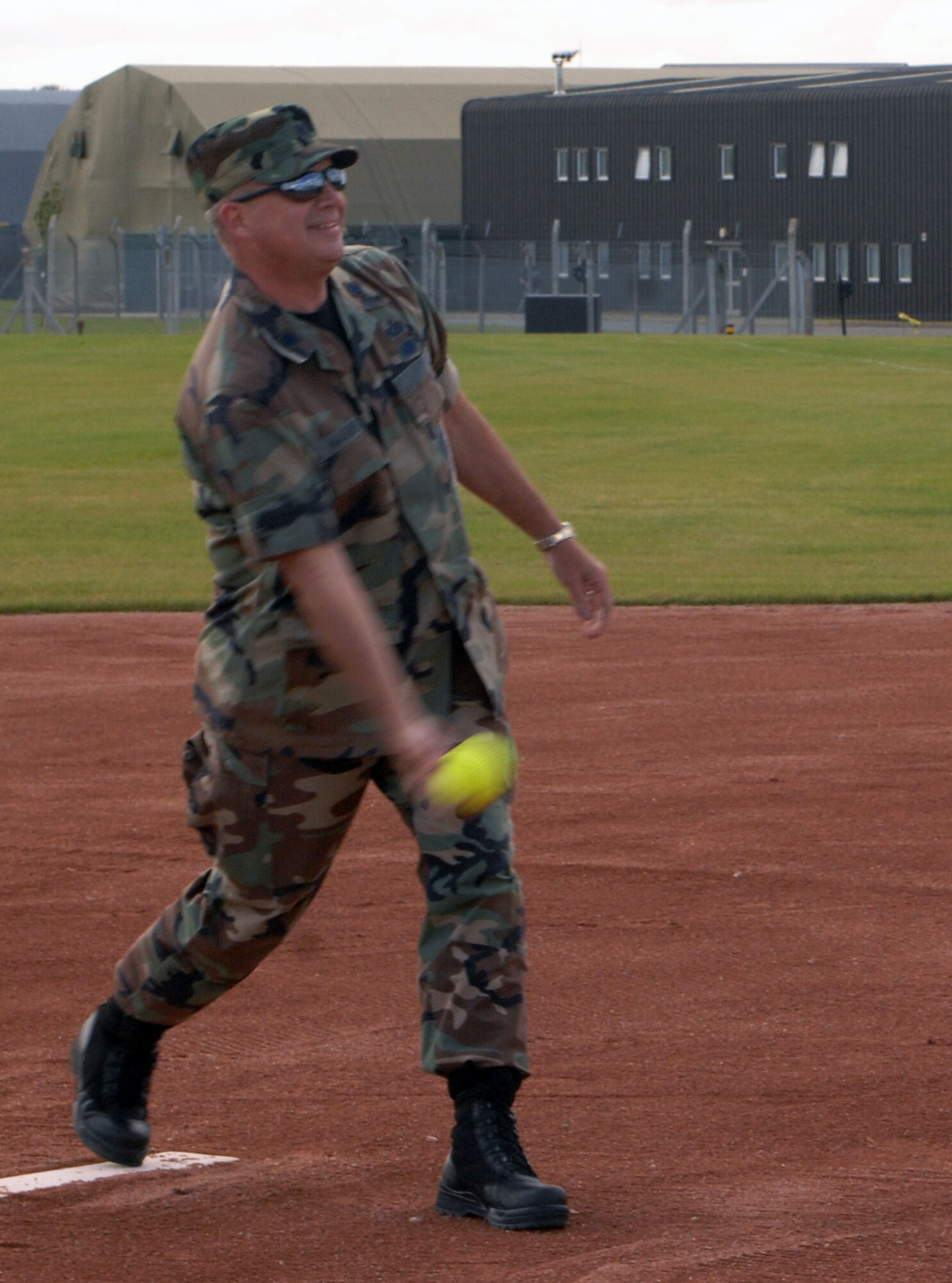 RAF MILDENHALL, England -- Lt. Col. Richard Wagner, 100th Force Support Squadron commander, throws the honorary first pitch during the intramural softball season opener on the recently completed south-side sports field. The field can be used for softball, soccer and flag football, and is a first at Mildenhall since the demolition of Ford Park two years ago. Although intramural sports always take precedence, anyone can use the field. (U.S. Air Force photo by Senior Airman Teresa M. Hawkins)