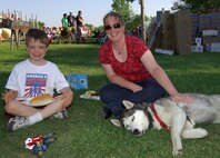 MINOT AIR FORCE BASE, N.D. -- Lisa Morris, wife of Capt. Chris Morris, 23rd Bomb Squadron, and their son, Christian, enjoy spending time with their Husky, Katya, during the Fourth of July picnic here. Minot Air Force Base’s annual Fourth of July picnic and fireworks display went off with a bang, highlighted by a spectacular fireworks display. The event was hosted by Community Center and 5th Force Support Squadron, which provided fun and entertainment for base residents. (U.S. Air Force photo by Senior Airman Kelly Timney)