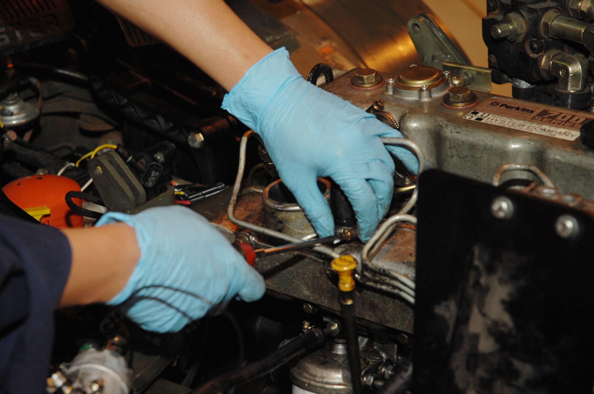 Staff Sgt. Alberto C. Gatcho, 48th LRS special purpose vehicle mechanic, works on rebuilding the engine of a forklift.  The engine shut down because the diesel fuel was not making it to the engine. (U.S. Air Force photo by Airman 1st Class Jessica Donnelly)