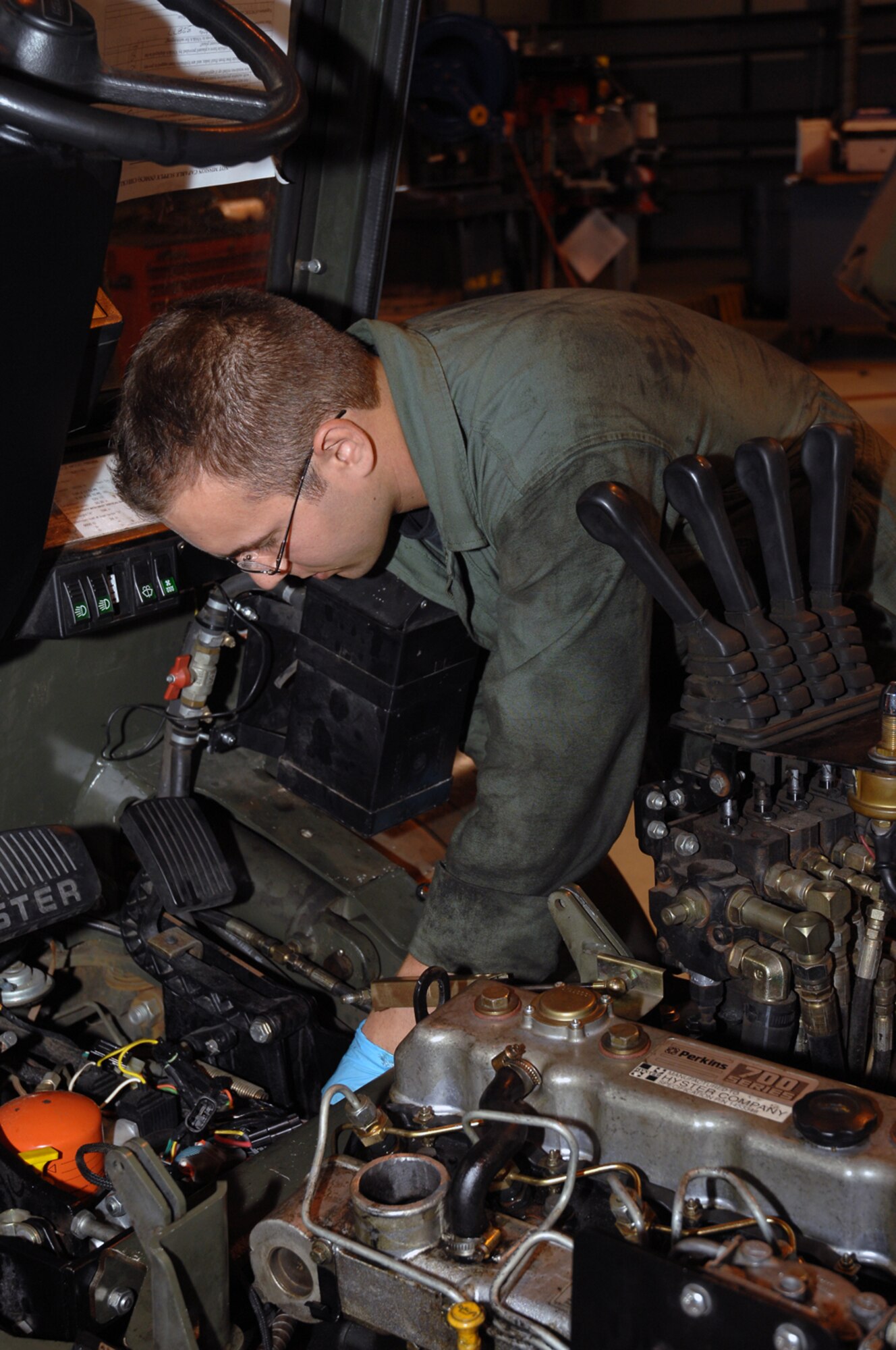 Airman 1st Class Alex Andrejkobics, 48th Logistics Readiness Squadron vehicle and equipment repair mechanic, works on the engine of a forklift.  The engine shut down because the diesel fuel was not making it to the engine and it had to be rebuilt. (U.S. Air Force photo by Airman 1st Class Jessica Donnelly)