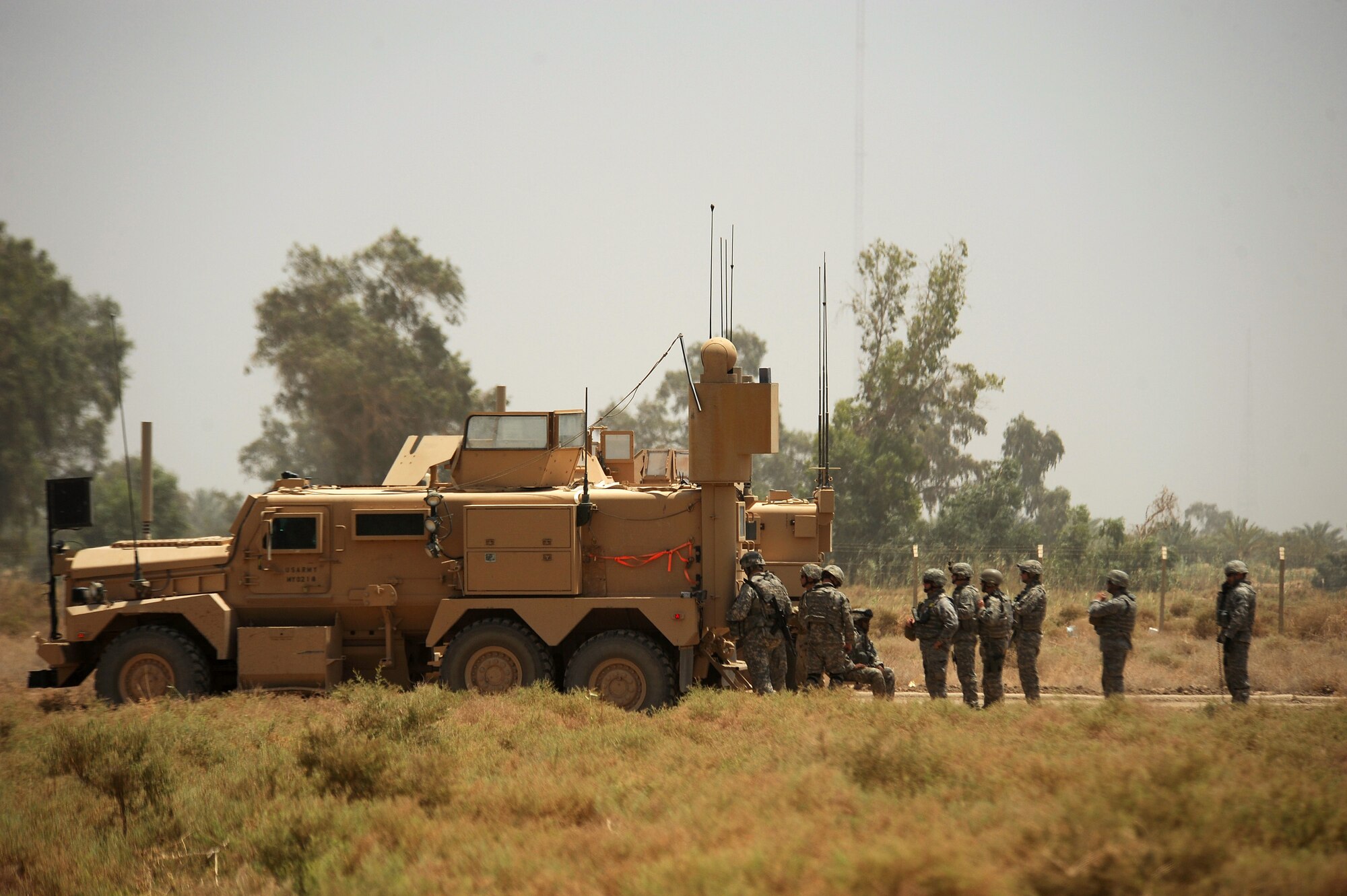 BAGHDAD, Iraq -- Explosive Ordinance Disposal personnel from the 447th Expeditionary Civil Engineer Squadron at Sather Air Base watch as a controlled detonation separates the forward section of a C-130 Hercules here July 7. The EOD team is using a series of controlled detonations designed to divide the airplane into smaller pieces so it can be moved. The C-130 made an emergency landing in a field north of Baghdad International Airport shortly after take-off June 27. (U.S. Air Force photo/Tech. Sgt. Jeffrey Allen)