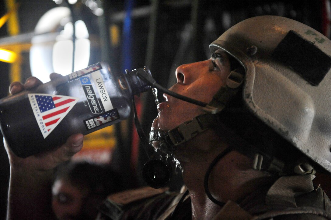 U.S. Air Force Staff Sgt. Daniel Houghton takes a break to keep hydrated after loading simulated patients into an HC-130P Hercules aircraft at the end of the mass casualty exercise on Moody Air Force Base, Ga., June 27, 2008. Houghton is a pararescueman assigned to the 38th Rescue Squadron.
 