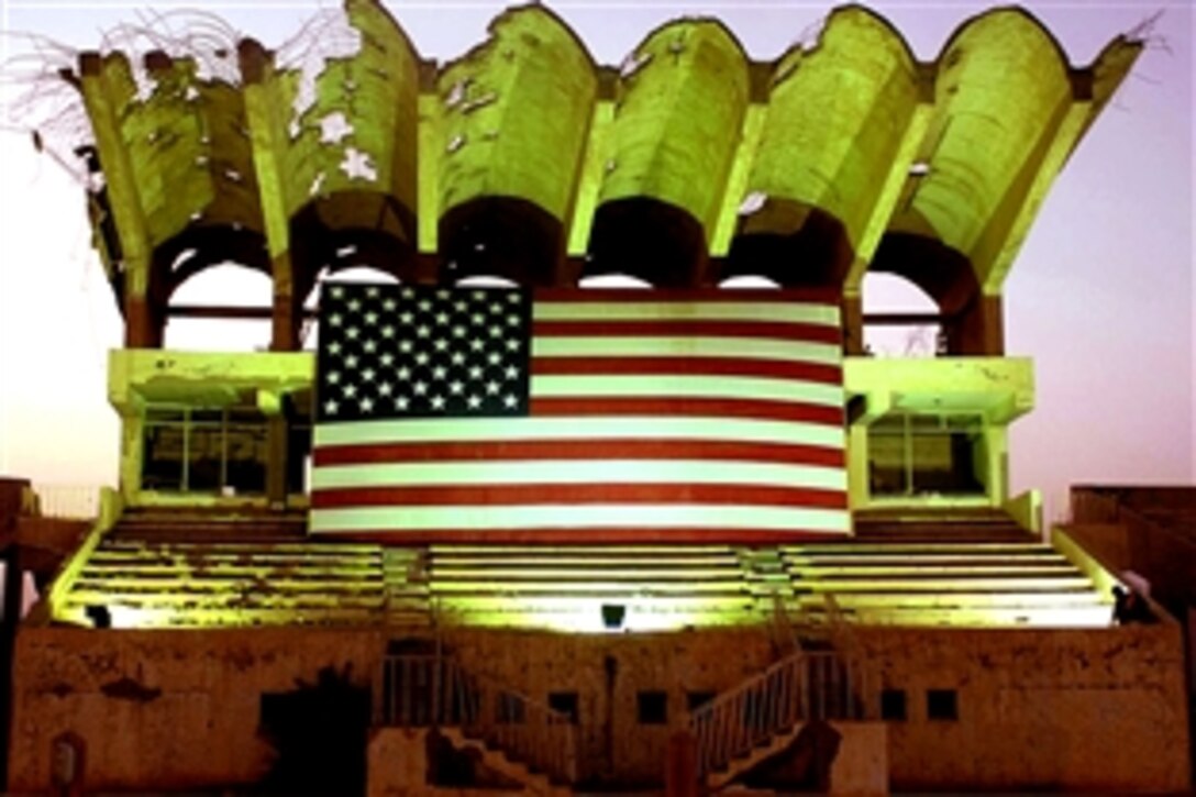 A worker fixes lighting to illuminate the U.S. flag for the Fourth of July activities on Contingency Operating Base Speicher in Tikrit, Iraq, July 4, 2008. 