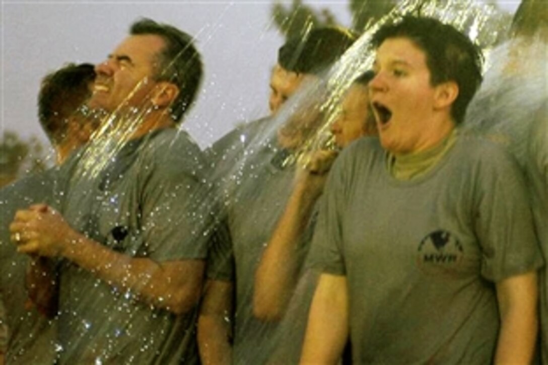 U.S. soldiers group together while having icy water thrown on them in a competition during Fourth of July activities on Contingency Operating Base Speicher in Tikrit, Iraq, July 4, 2008. 

