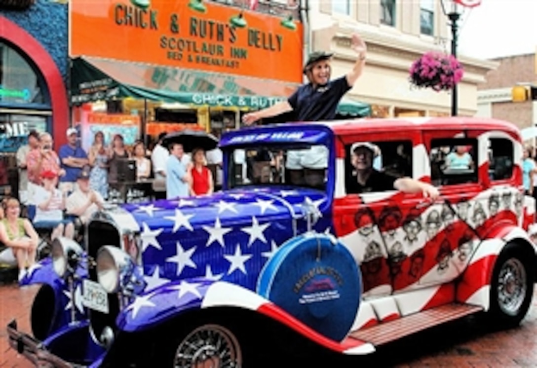 Ted Levitt, owner of Chick and Ruth’s Delly in Annapolis, Md., advertises his Faces of Valor USA project outside his downtown restaurant. Levitt had the faces of heroes airbrushed on a restored 1931 Buick he plans to show to raise funds for scholarships and financial assistance for those wounded or killed while serving. 