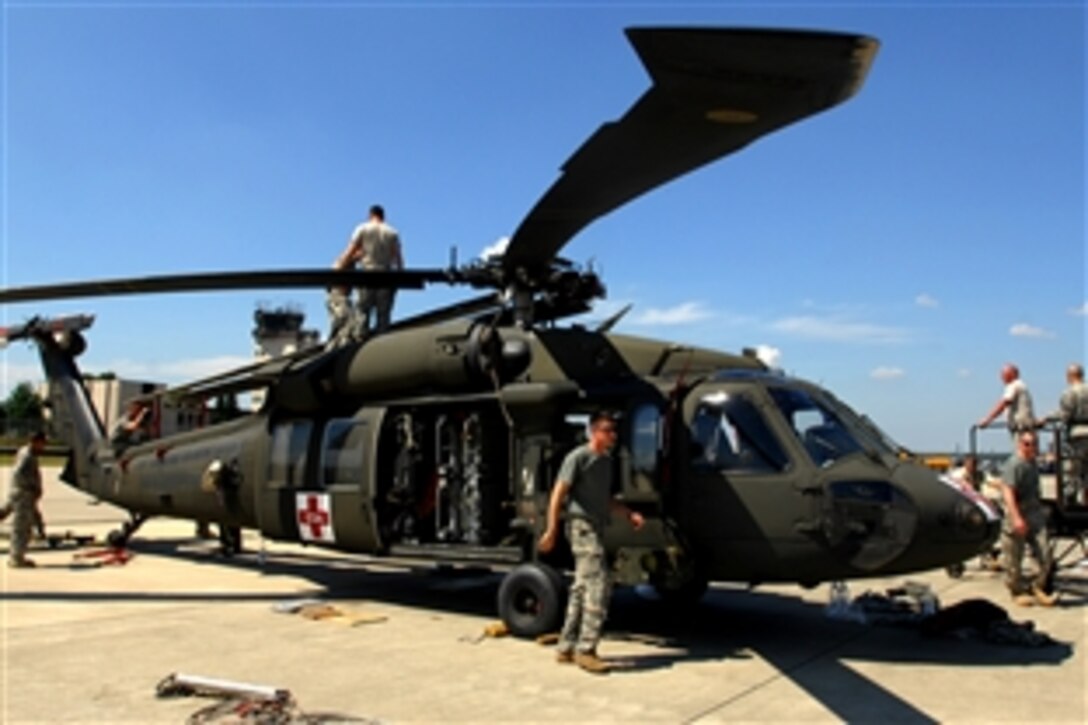U.S. Army soldiers fold blades of a UH-60A Blackhawk helicopter on Ramstein Air Base, Germany, July 2, 2008. The soldiers assigned to Charlie Company 5th Battalion, 158th Aviation Regiment from Katterbach Army Airfield, Germany, were preparing the Blackhawk for an air transport to the Republic of Georgia.