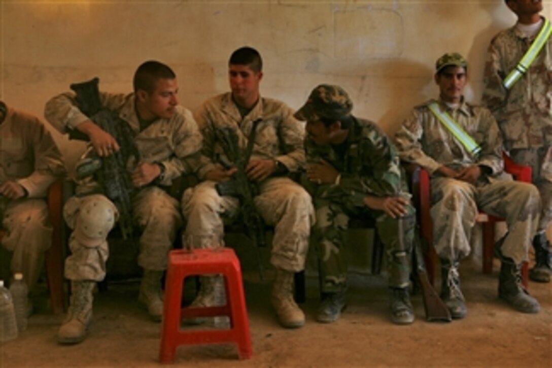 U.S. Marines with the 2nd Light Armored Reconnaissance Battalion, Task Force Mechanized, Multi-National Force - West speak with an Iraqi soldier about their current mission in the Jazeerah Desert in Iraq on July 3, 2008.  Marines with the task force are conducting disruption missions as part of an operation to prevent foreign fighters from entering the area.  