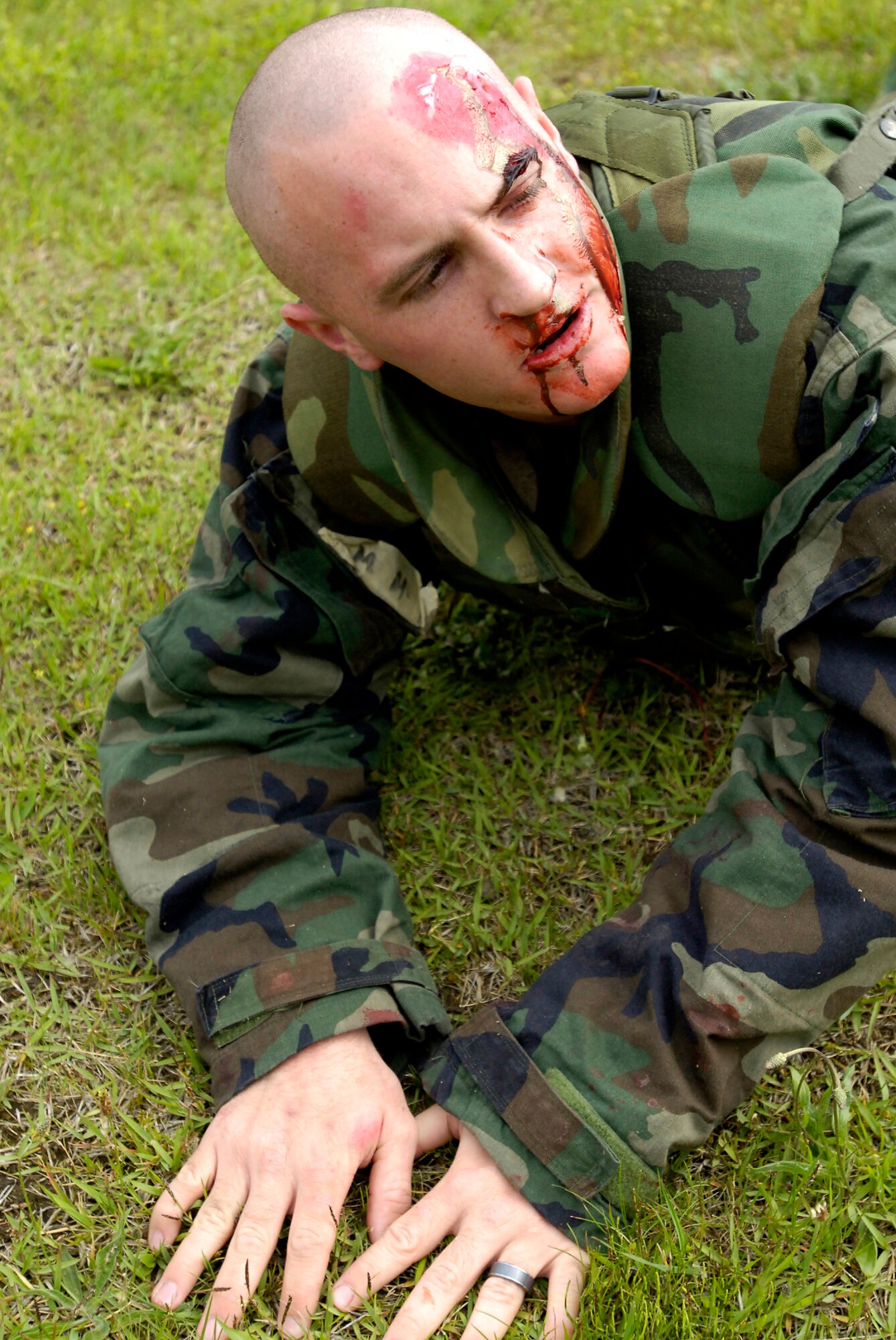 MISAWA AIR BASE, Japan -- An Airman simulates being in pain after a simulated attack during exercise Beverly Sunrise June 26, 2008.  The three-day exercise tested and pushed Airmen to their limits. (U.S. Air Force photo by Senior Airman Chad Strohmeyer)