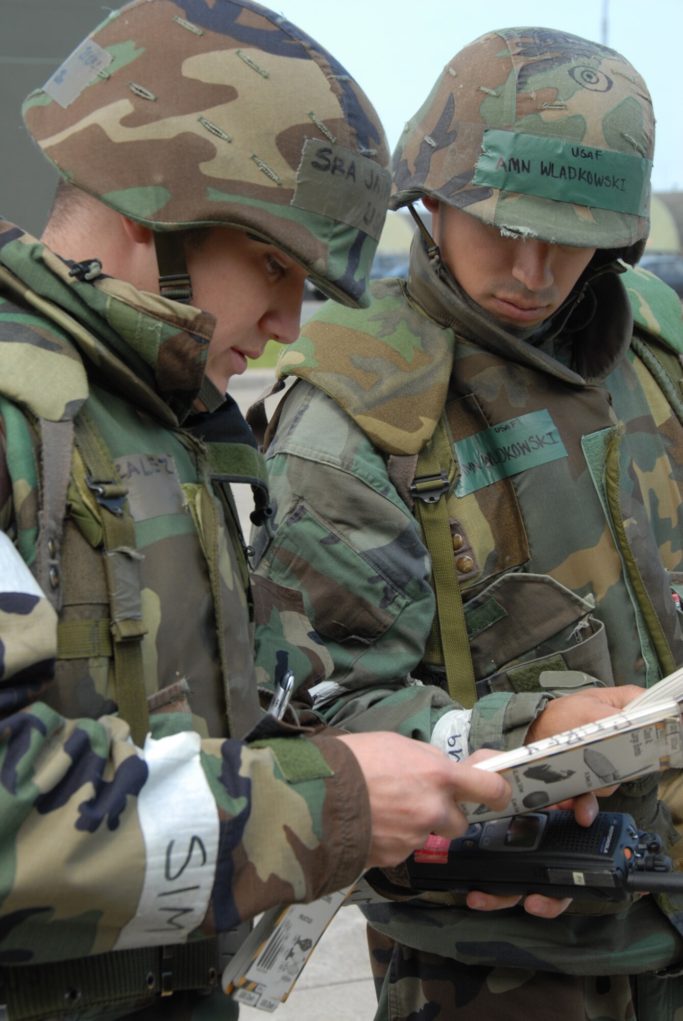 MISAWA AIR BASE, Japan -- Senior Airman Jaime Gonzalez and Airman Michael Wladkowski, 35th LRS, try to identify an unexploded ordinance following a simulated ground attack during a combat evaluation readiness exercise June 26, 2008.  The 35th Fighter Wing participated in an exercise June 24 - 26 to test their combat capabilities in a wartime environment.  (U.S. Air Force photo by Senior Airman Laura McFarlane)