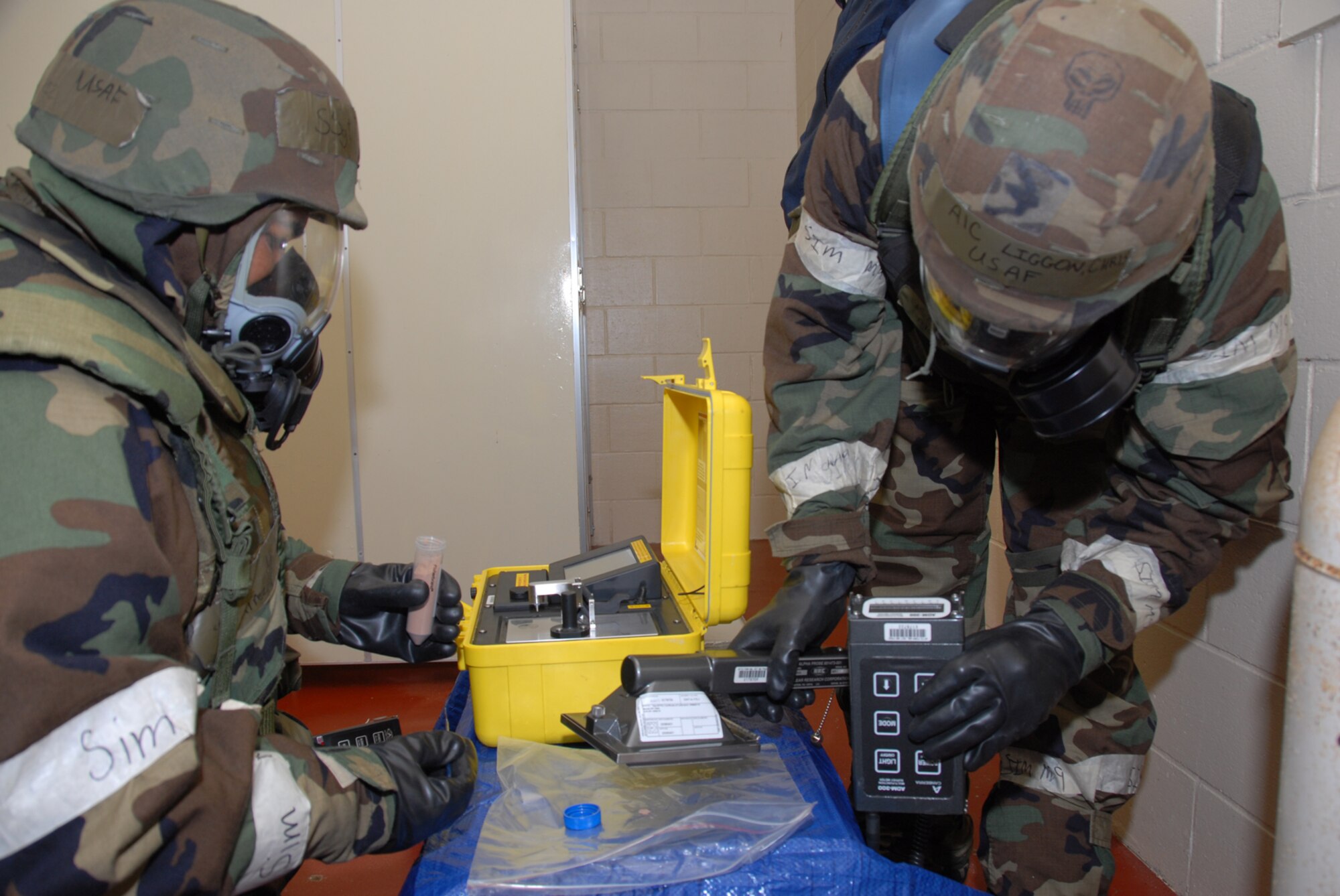 MISAWA AIR BASE, Japan -- Staff Sgt. Joseph Ramirez, 35th AMDS, and Airman 1st Class Christopher Liggon, 35th CES, test an unknown substance during a combat employment readiness exercise June 24, 2008.  The CERE is designed to test a wing's ability to survive and operate in a wartime environment.   (U.S. Air Force photo by Senior Airman Laura McFarlane)