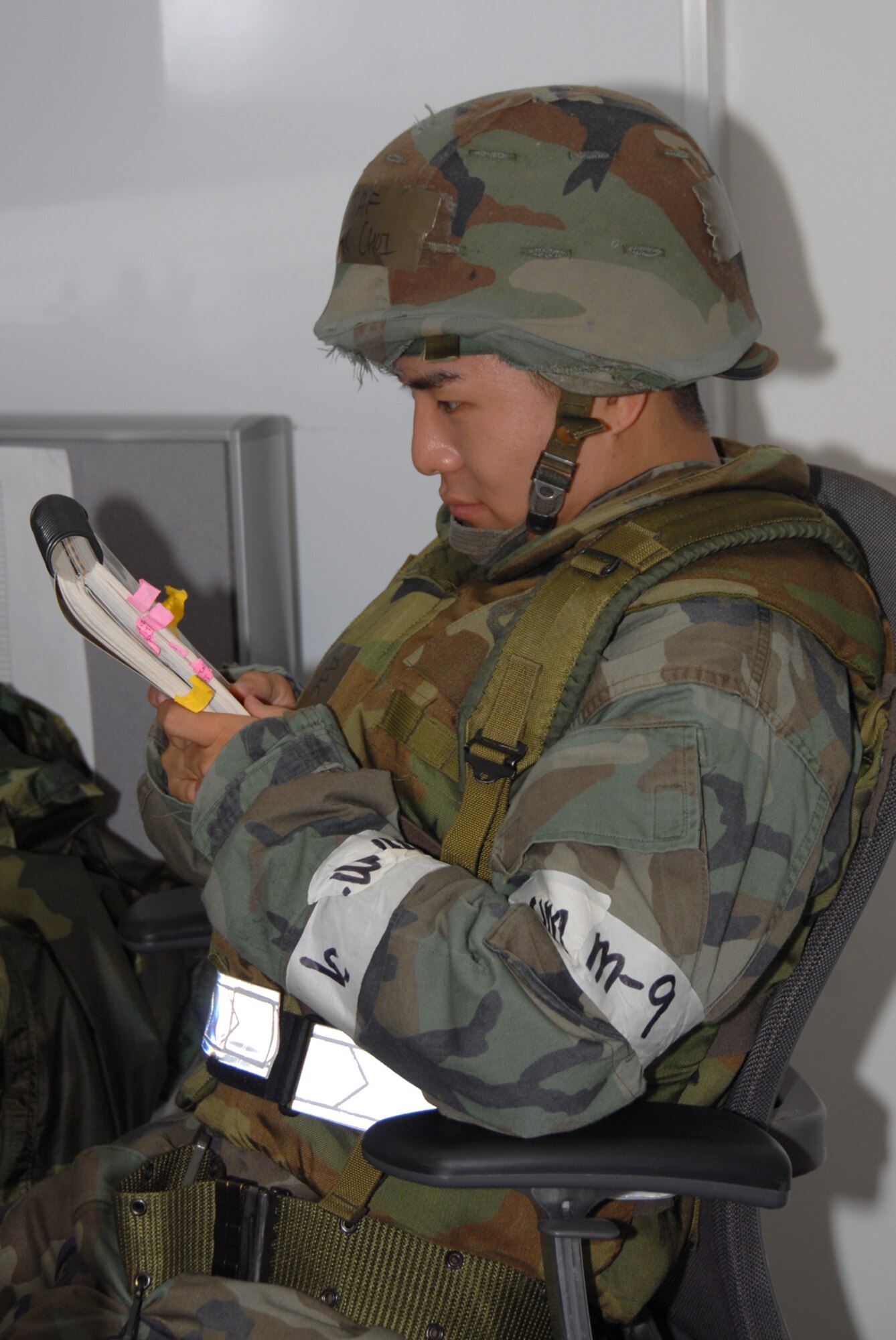MISAWA AIR BASE, Japan -- Airman 1st Class Issac Choi, 35th Communications Squadron, studies his Airman's manual during a combat employment readiness exercise June 25, 2008.  Airmen took to studying their Airman's manual during less active portions of the CERE.   (U.S. Air Force photo by Senior Airman Laura McFarlane)