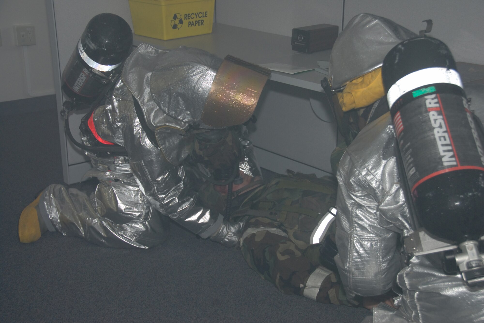 MISAWA AIR BASE, Japan -- Firefighters from the 35th Civil Engineer Squadron rescue an Airman from a simulated fire during a combat employment readiness exercise June 24, 2008.  The CERE is designed to test a wing's ability to survive and operate in a wartime environment.   (U.S. Air Force photo by Senior Airman Laura McFarlane)