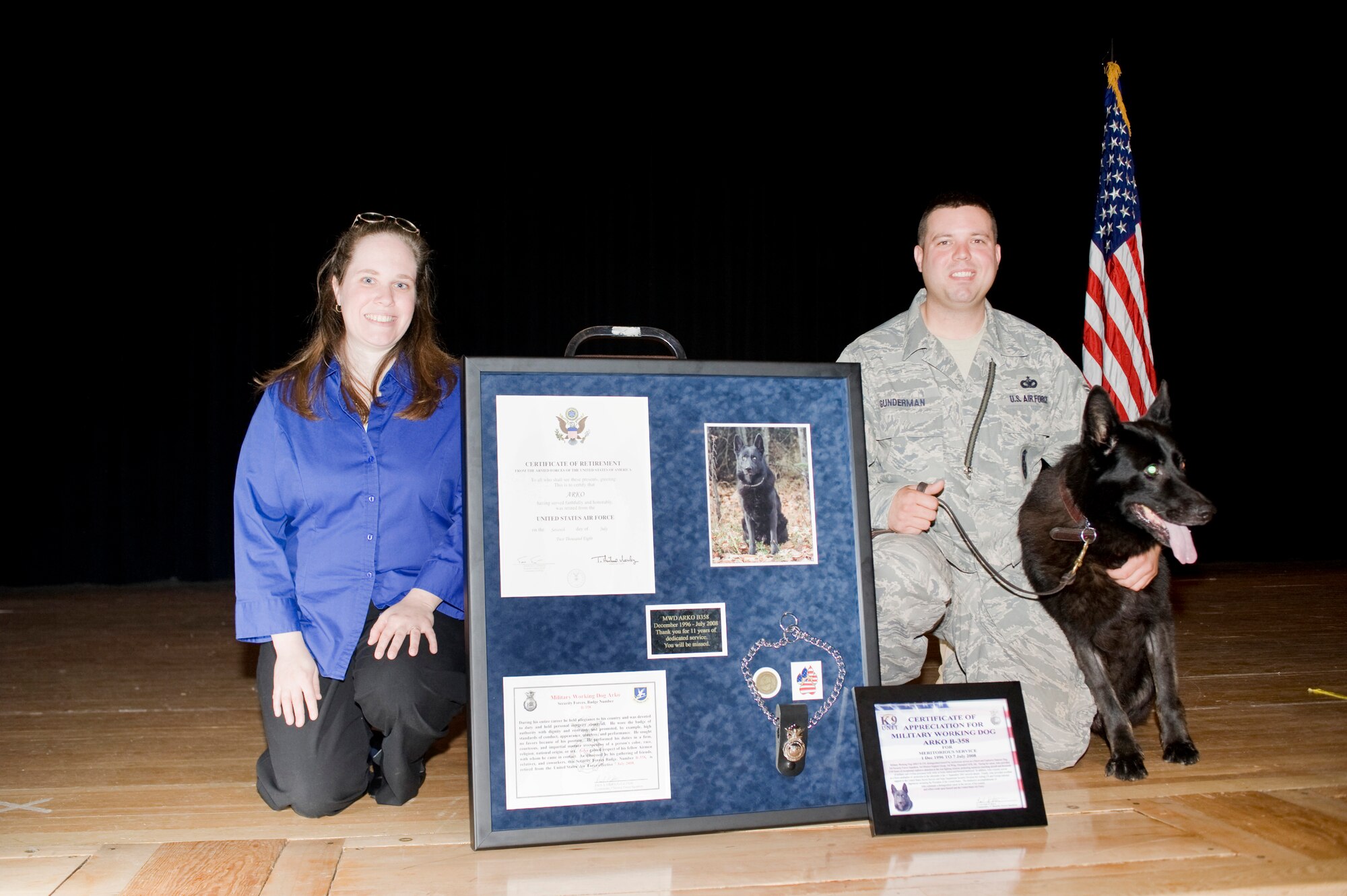 ELMENDORF AIR FORCE BASE, Alaska ? Military working dog Arko sits next to his handler, Staff Sgt. Christopher Gunderman, 3rd Security Forces Squadron, and wife, Monica, to pose for a photograph during his retirement ceremony July 7. Arko has served 11 years in the Air Force and been deployed 5 times to the Middle East. (U.S. Air Force photo/Senior Airmen Jonathan Steffen)