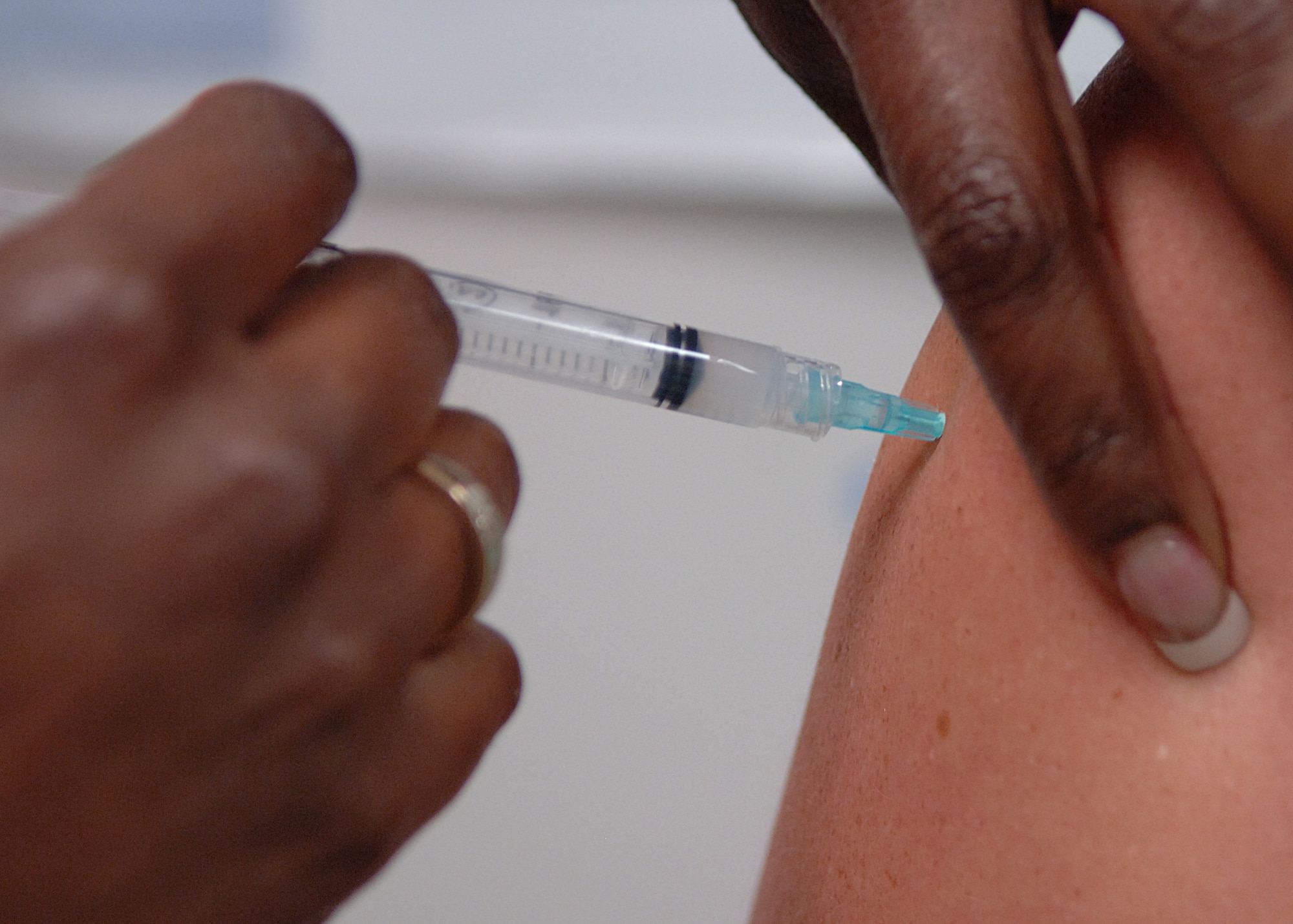 Tech. Sgt. Cassandra Williams, 49th Aeromedical Dental Squadron, administers a tetanus shot to Mrs. Linda Campbell in the 49th Medical Group's Immunization Clinic at Holloman Air Force Base, N.M., July 9. Patients who feel their immunization records are not up to date, or are unsure, should contact the clinic directly. (U.S. Air Force photo/Airman 1st Class John Strong) 
  