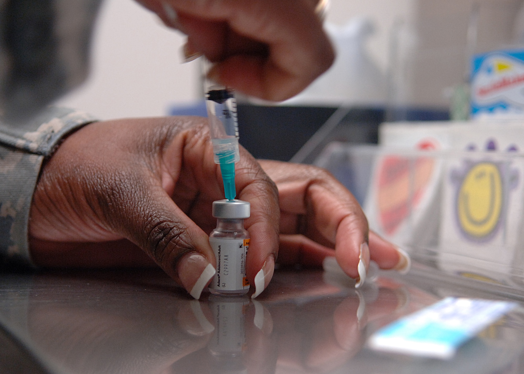 Tech. Sgt. Cassandra Williams, 49th Aeromedical Dental Squadron, prepares a tetanus shot in the 49th Medical Group's Immunization Clinic at Holloman Air Force Base, N.M., July 9. The tetanus vaccine is an inactivated toxin called a toxoid. It is made by growing the bacteria in a liquid medium and purifying and inactivating the toxin. Because it is not a live vaccine, a person's immunity tends to decline with time, which is why booster doses are recommended.  (U.S. Air Force photo/Airman 1st Class John Strong) 
  