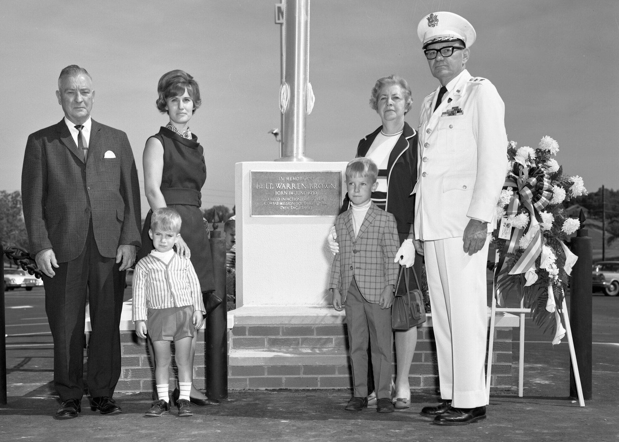 The family of Lt Warren Brown stands by the brown memorial in the parking lot of the Bellas Hess Superstore. Sioux City, Iowa May 1969.
On 14 July 1968, 1st Lt Warren K. Brown was on an air strike mission in the AShau Valley. (Vietnam) As he made his pass over the target area, his aircraft was hit by ground fire. He headed in an easterly direction and bailed out shortly afterwards as his aircraft was on fire. During the ejection, there was a chute entanglement and the pilot was found deceased in his chute harness by a helicopter crew.
Brown was the only pilot of the Sioux City based 185th Air National Guard to be killed in Vietnam.