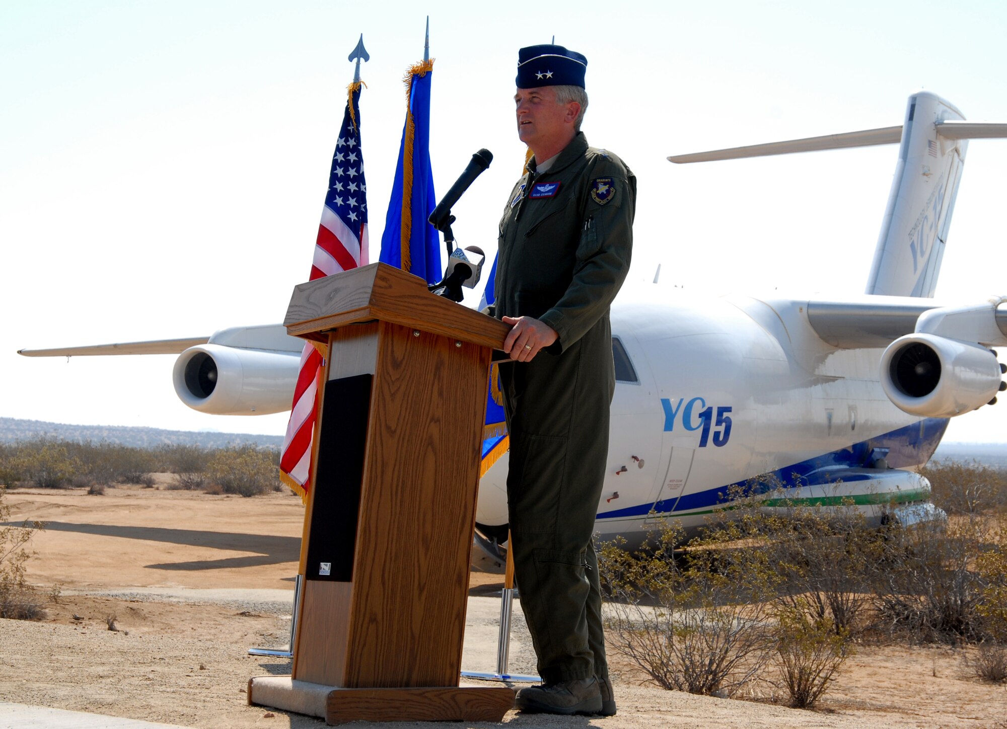 Maj. Gen. David Eichhorn, Air Force Flight Test Center commander, welcomes attendees to the dedication ceremony of the YC-15 to the Century Circle display at the West Gate on Rosamond Boulevard July 8. The aircraft flew for the first time over Edwards on Aug. 26, 1975. (Air Force photo by Senior Airman Stacy Sanchez) 
