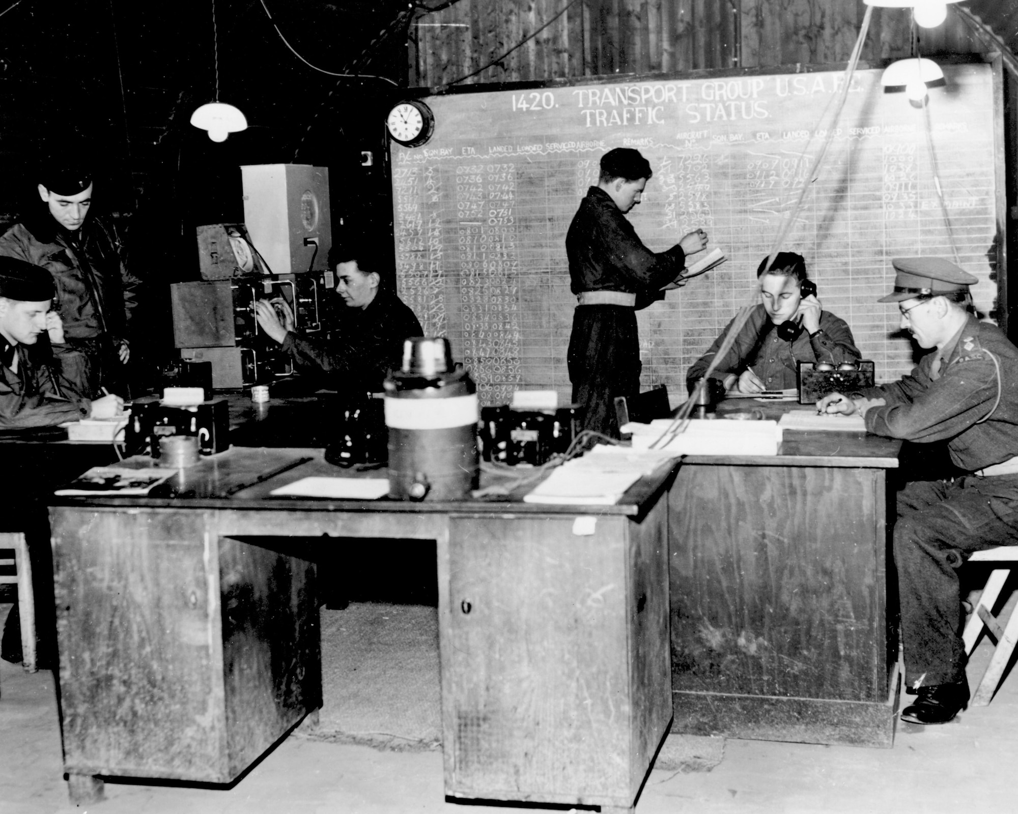 Radio calls from incoming aircraft were monitored by personnel at the traffic control point during the Berlin Airlift in 1948. The traffic control point used this information to help facilitate loading operations. Pictured are from Left to right: Lt. Howard L. Pruden, Lt. Ralph A. Lerch, Driver Peter K. Davis, Driver James Anderson, Lance Cpl. Horton Albert, Capt. Donald Barker. (Courtesy photo)