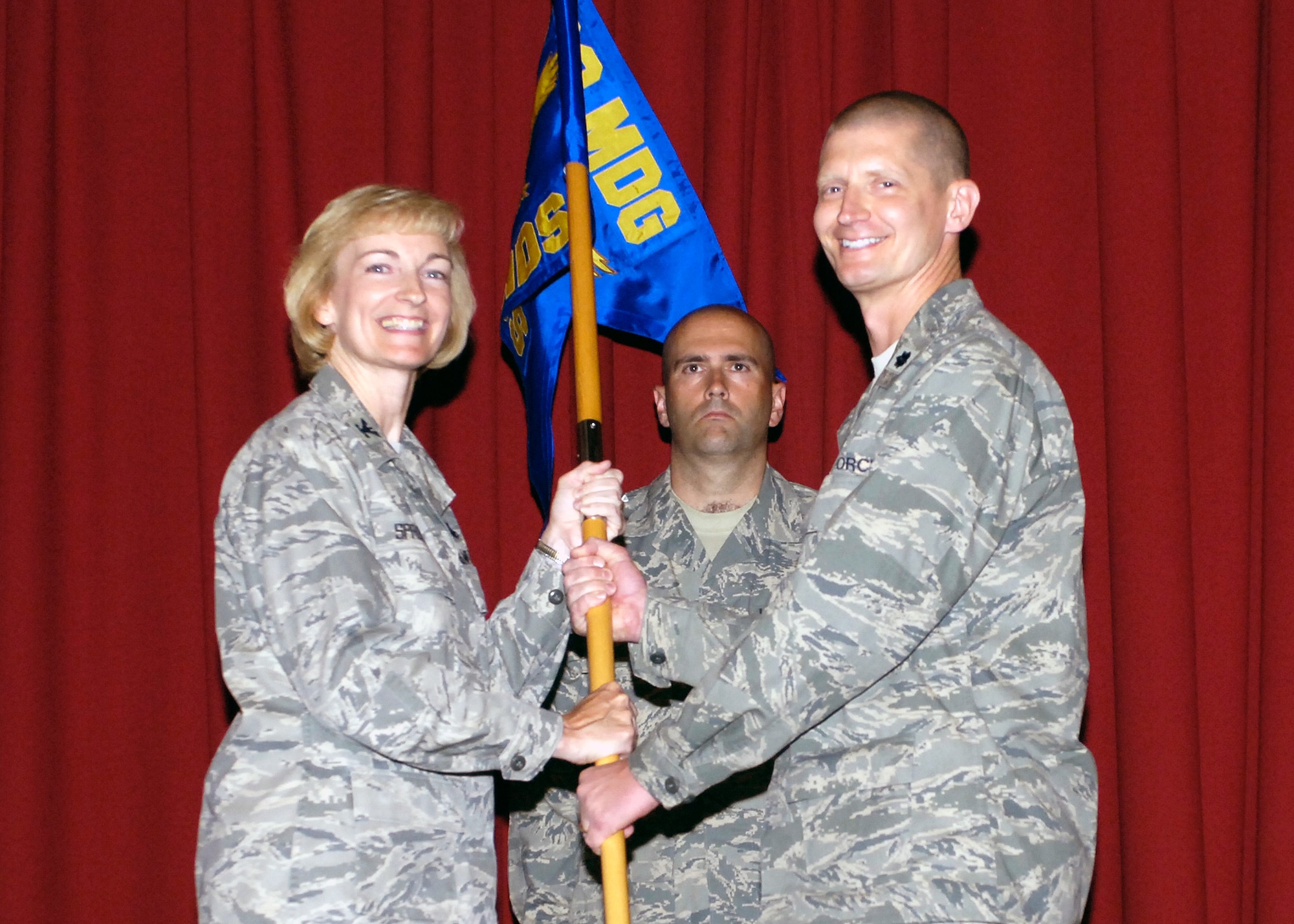 FAIRCHILD AIR FORCE BASE, Wash. - Col. Anne Sproul, 92nd Medical Group commander, presents Lt. Colonel Paul Nelson, 92nd Aerospace Medicine Squadron commander, with the squadron guide-on during the 92nd AMDS change-of-command ceremony here July 8. Colonel Nelson was Chief of Aeromedical Services, 14th Medical Group, Columbus Air Force Base, Miss., prior to his arrival at Fairchild. He succeeds former 92nd AMDS commander Col. Lisa Kuhar. (U.S. Air Force photo / Airman 1st Class Melissa Barnett)