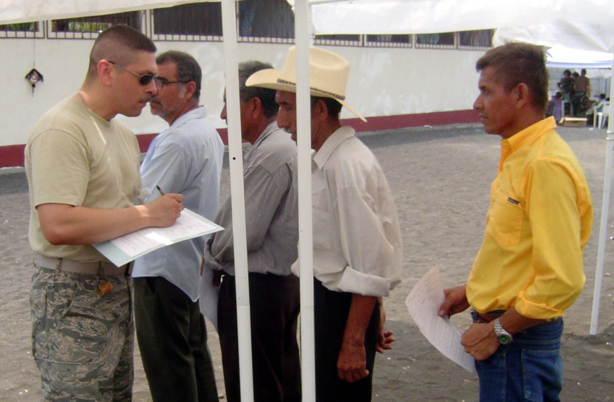 Tech. Sgt. Eric Gaona (Left) registers patients at a medical site in Guatemala while deployed in support of Operation Continuing Promise recently. (U.S. Air Force photo)