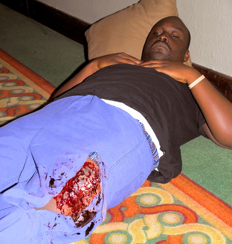 Staff Sgt. Emmrid Gilbert plays the role of a victim with a femur fracture at a Honduran medical conference July 8 in Tegucigalpa, Honduras. The Joint Task Force-Bravo Medical Element team member played the role to give the medical professionals who attended a more realistic view of a trauma case. Sergeant Gilbert is deployed from the U. S. Air Force Academy, Colo. (U.S. Air Force photo/Staff Sgt. Joel Mease)