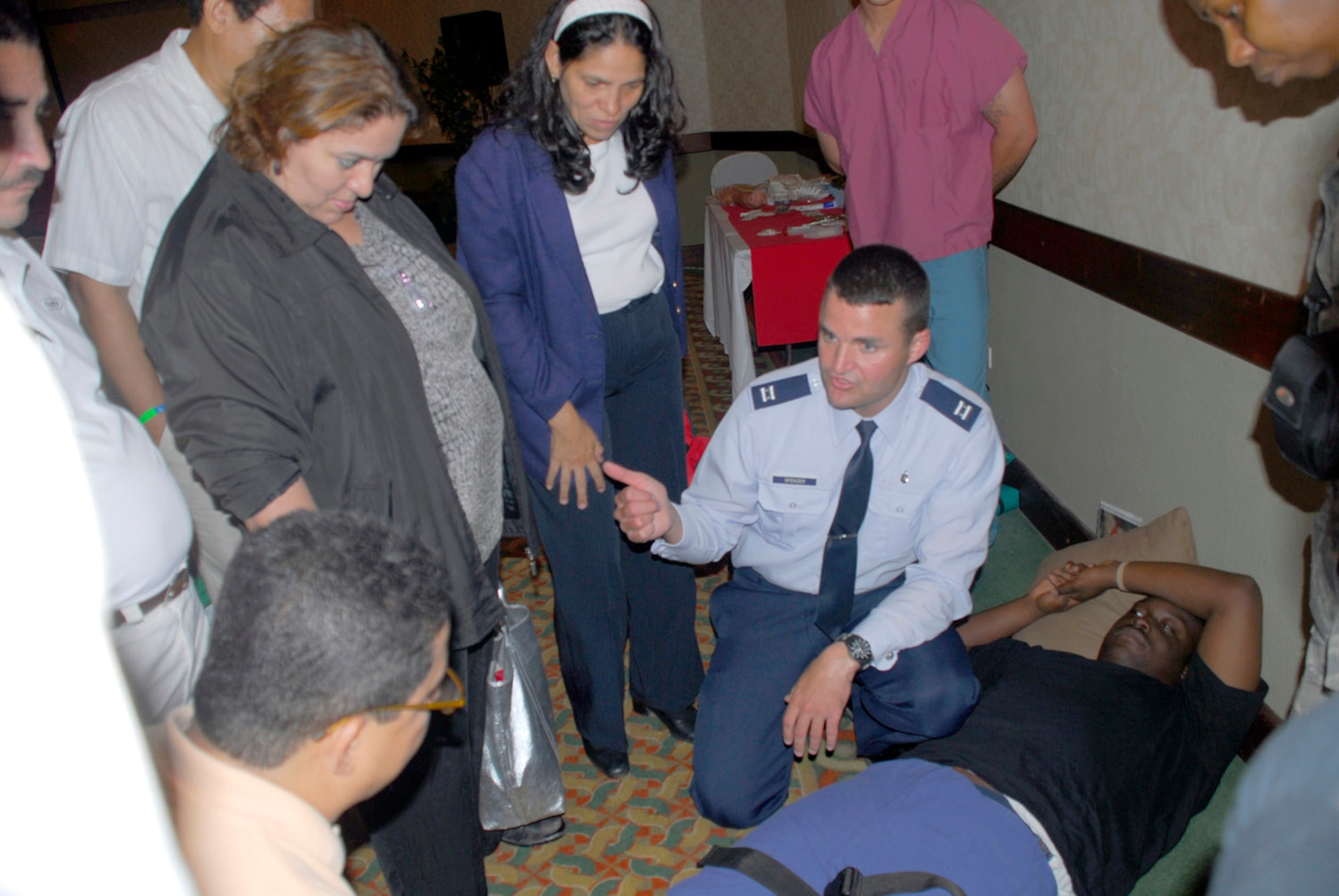 Capt. Dennis Spencer discusses with a group of Honduran doctors and health technicians techniques used in dealing with fractures at a Honduran medical conference July 8 in Teguicigalpa, Honduras. More than 200 medical professionals from across Honduras attended the course offered by Joint Task Force-Bravo Medical Element. Captain Spencer is deployed from Elmendorf Air Force Base, Alaska. (U.S. Air Force photo/Staff Sgt. Joel Mease)