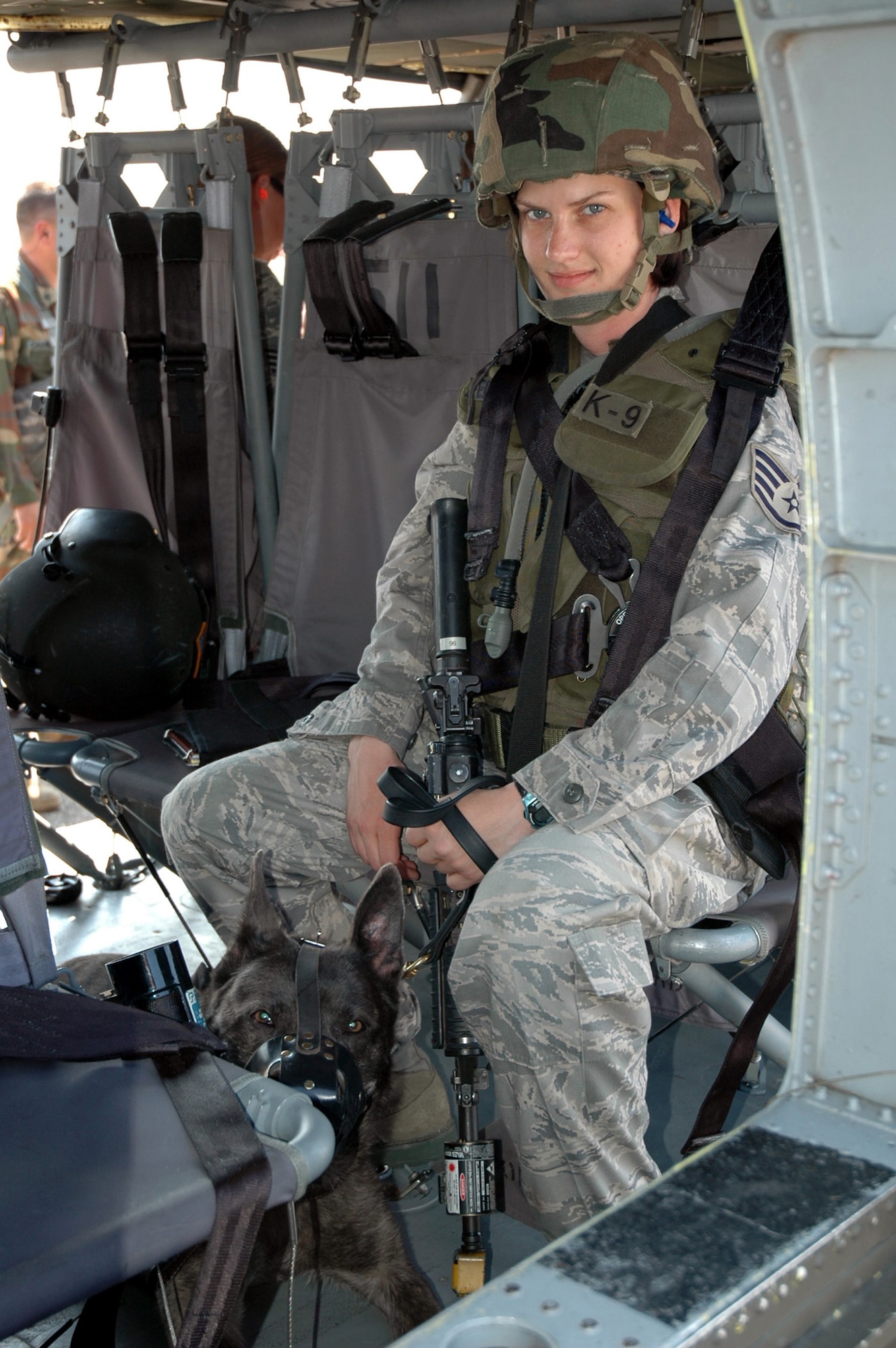 Staff Sgt. Kristyne Feldman and her military working dog Berry, both students in the U.S. Air Force Expeditionary Center's Phoenix Warrior Training Course canine track, learn about loading and unloading aboard a Blackhawk helicopter July 8, 2008, on Fort Dix, N.J.  The instruction was part of training for the course where military working dog teams learn to fly aboard helicopters.  Phoenix Warrior is taught by the USAF EC's Expeditionary Operations School and 421st Combat Training Squadron preparing security forces for upcoming deployments.  (U.S. Air Force Photo/Staff Sgt. Paul R. Evans)