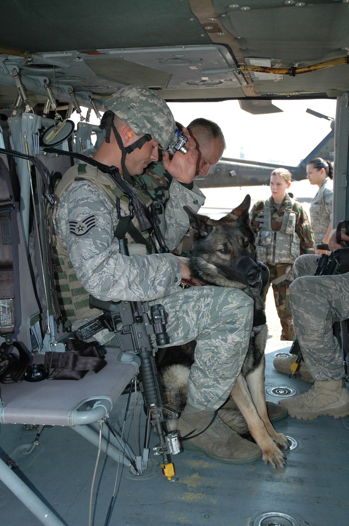 Students in the U.S. Air Force Expeditionary Center's Phoenix Warrior Training Course canine track, learn about loading and unloading aboard a Blackhawk helicopter July 8, 2008, on Fort Dix, N.J.  The instruction was part of training for the course where military working dog teams learn to fly aboard helicopters.  Phoenix Warrior is taught by the USAF EC's Expeditionary Operations School and 421st Combat Training Squadron preparing security forces for upcoming deployments.  (U.S. Air Force Photo/Staff Sgt. Paul R. Evans)