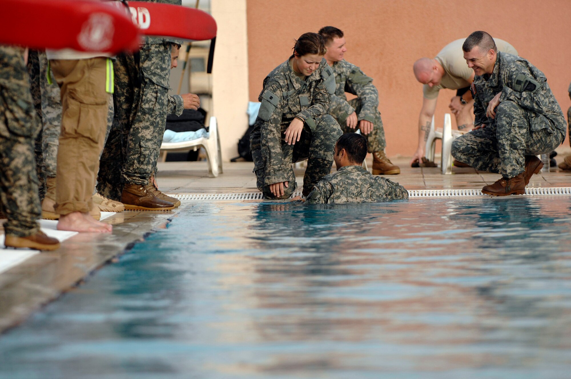 JOINT BASE BALAD, Iraq (AFPN) -- Soldiers from Bravo Company 2nd Battalion, 320th Field Artillery Regiment, and Airmen from the 332nd Air Expeditionary Wing conduct water skills training here July 8. The training, consisting of a 25-meter swim in full uniform and five minutes of treading water, is designed to make sure the Soldiers and Airmen can function in the water and that they will be able to respond and react during operations in varying watery terrains. (U.S. Air Force photo/ Senior Airman Julianne Showalter)