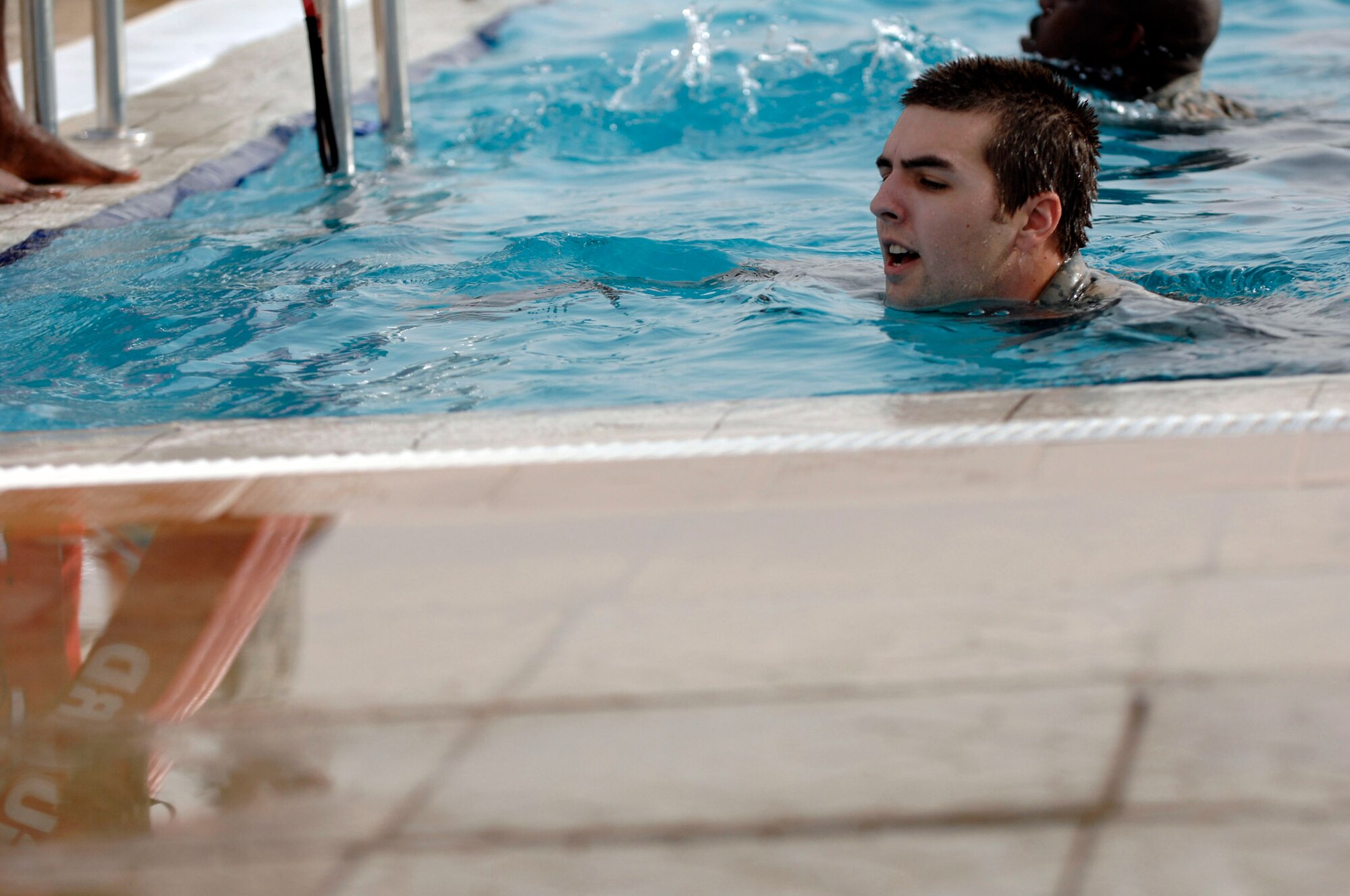 Senior Airman Justin Bavery treads water to ensure proficiency in watery terrains here July 8. Airman Bavery is a 332nd Expeditionary Civil Engineer Squadron explosive ordnance disposal technician at Joint Base Balad, Iraq. (U.S. Air Force photo/Senior Airman Julianne Showalter)