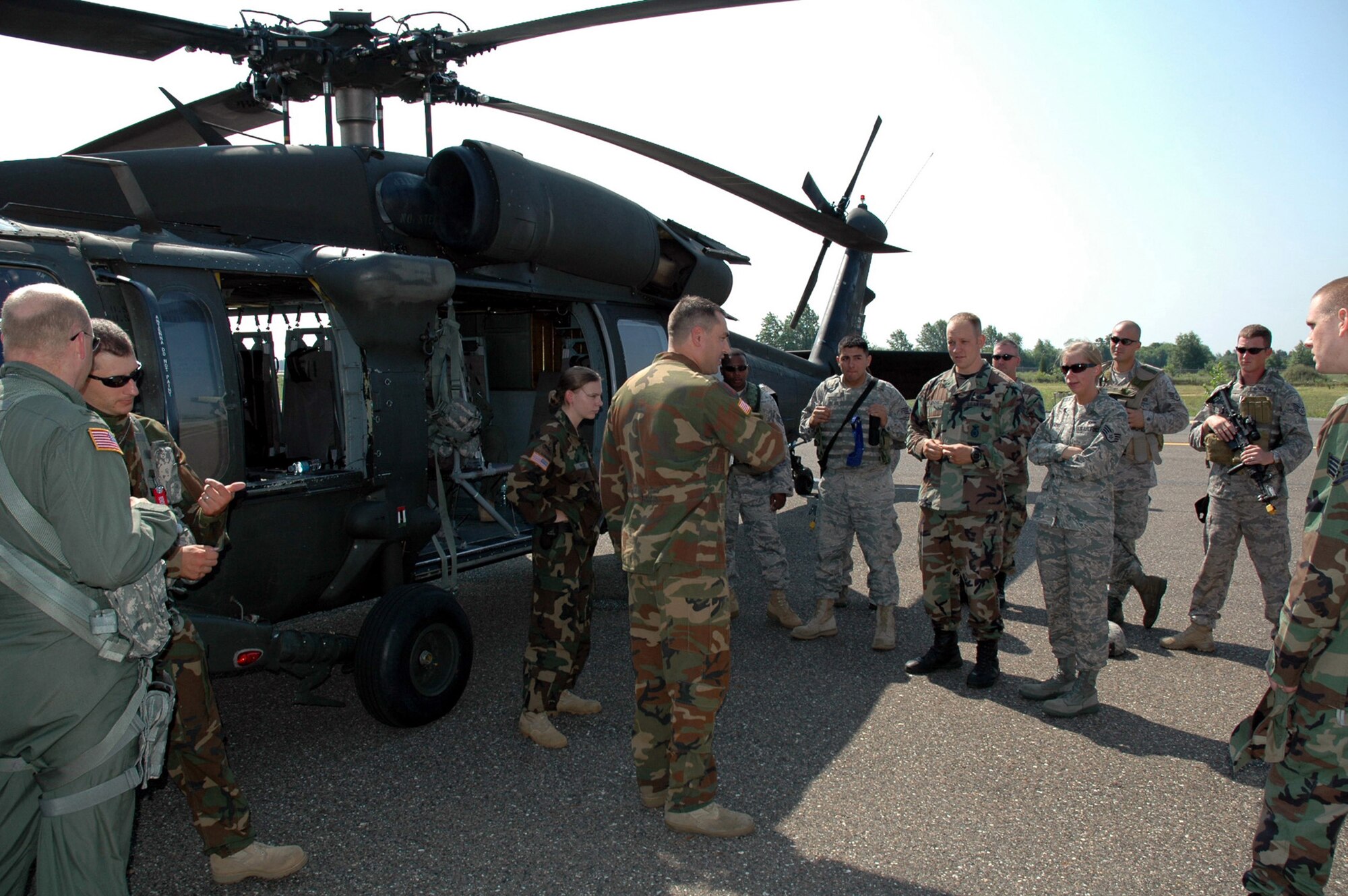 U.S. Army personnel instruct Air Force security forces personnel who are students in the U.S. Air Force Expeditionary Center's Phoenix Warrior Training Course canine track about a Blackhawk helicopter July 8, 2008, on Fort Dix, N.J.  The instruction was part of training for the course where military working dog teams learn to fly aboard helicopters.  Phoenix Warrior is taught by the USAF EC's Expeditionary Operations School and 421st Combat Training Squadron preparing security forces for upcoming deployments.  (U.S. Air Force Photo/Staff Sgt. Paul R. Evans)