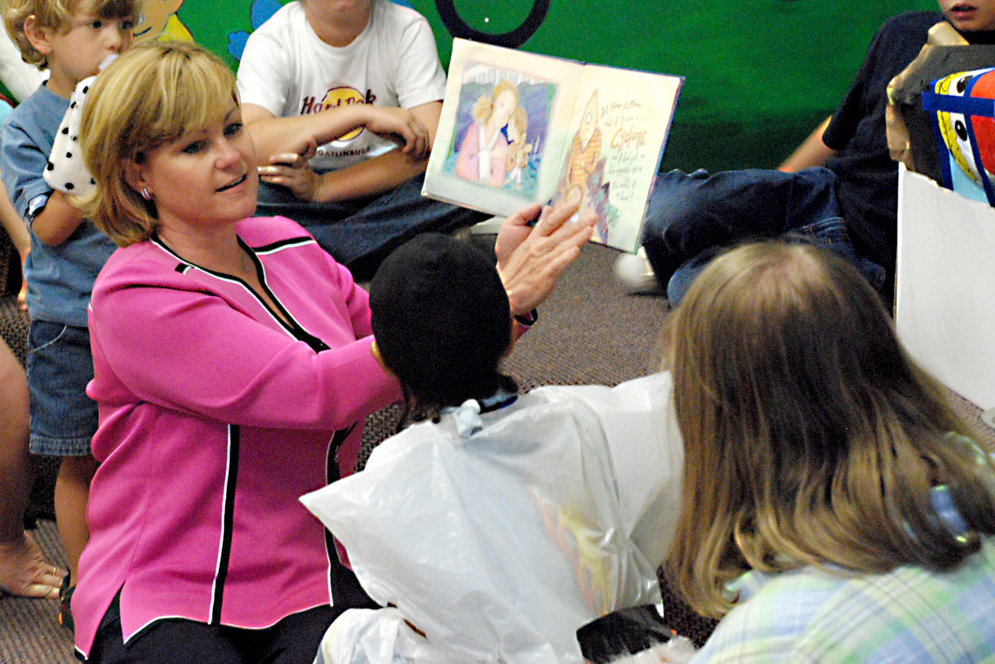 Sharon Burg, Twentieth Air Force Commander Maj. Gen. Roger W. Burg’s wife, reads stories to children at the communibrary during her visit to the missile wing last week. While General Burg observed the mission oriented aspects of the base, Mrs. Burg traveled to different places of the base to see the quality of living (Photo by Airman 1st Class Daryl Knee).
