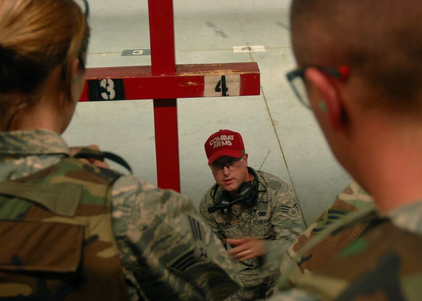SEYMOUR JOHNSON AIR FORCE BASE, N.C. - Senior Airman Charles Poling instructs Airmen attending the M-16 qualifying course on how to calibrate the sights on their weapons here July 2. Airmen must periodically qualify on the M-16 to remain deployable. (U.S. Air Force photo by Airman 1st Class Makenzie R. Lang) 