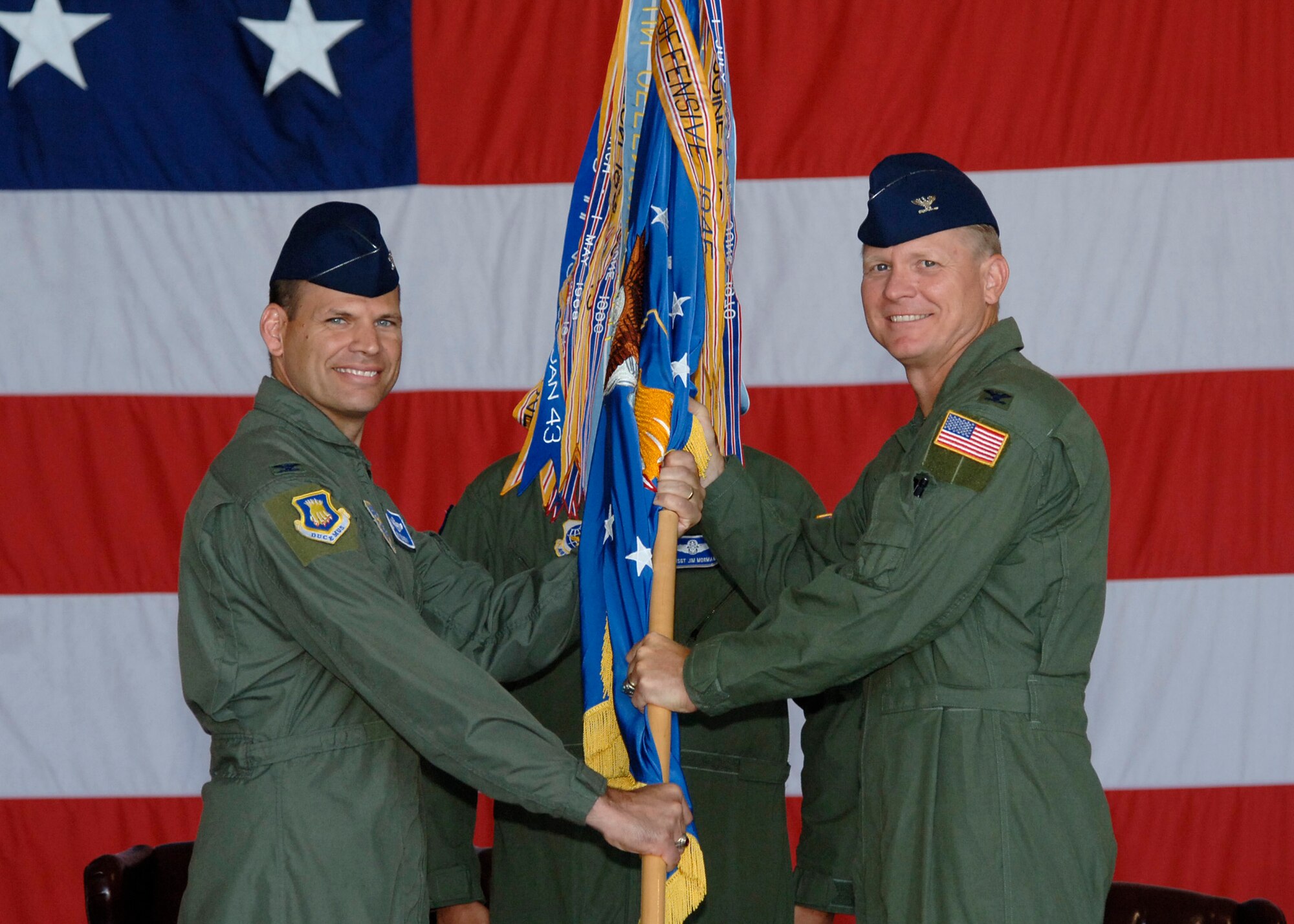 MCCONNELL AIR FORCE BASE, Kan. -- Col. James C. Vechery, 22nd Air Refueling Wing commander, left, hands guide on to Col. Bart Weiss, taking command of the 22nd Operations Group during a change of command ceremony here, July 7. (Photo by Senior Airman Anthony Mejia)