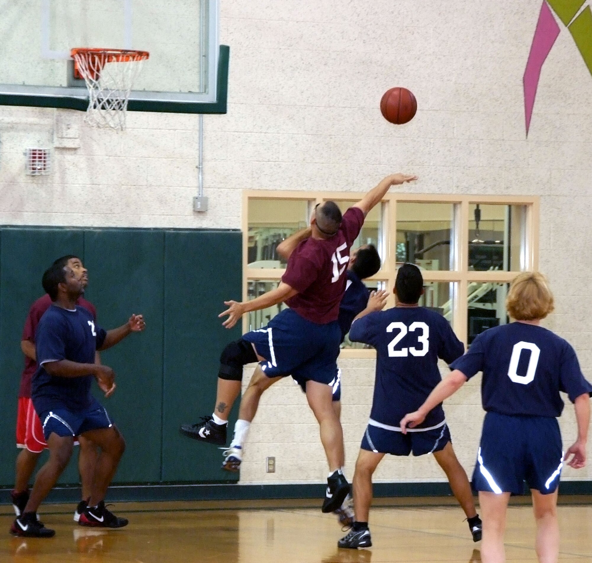 Tech Sgt. Jon Cabatit, 15, blocks a basket attempt during the Commander’s Challenge basketball game held Wednesday, July 9, in the reopened Fitness Center gymnasium at Vance AFB, Okla. A new air-conditioning system kept the spectators comfortable as the commanders team lost to the base-populous team, 44-38. (U.S. Air Force photo by Terry Wasson)