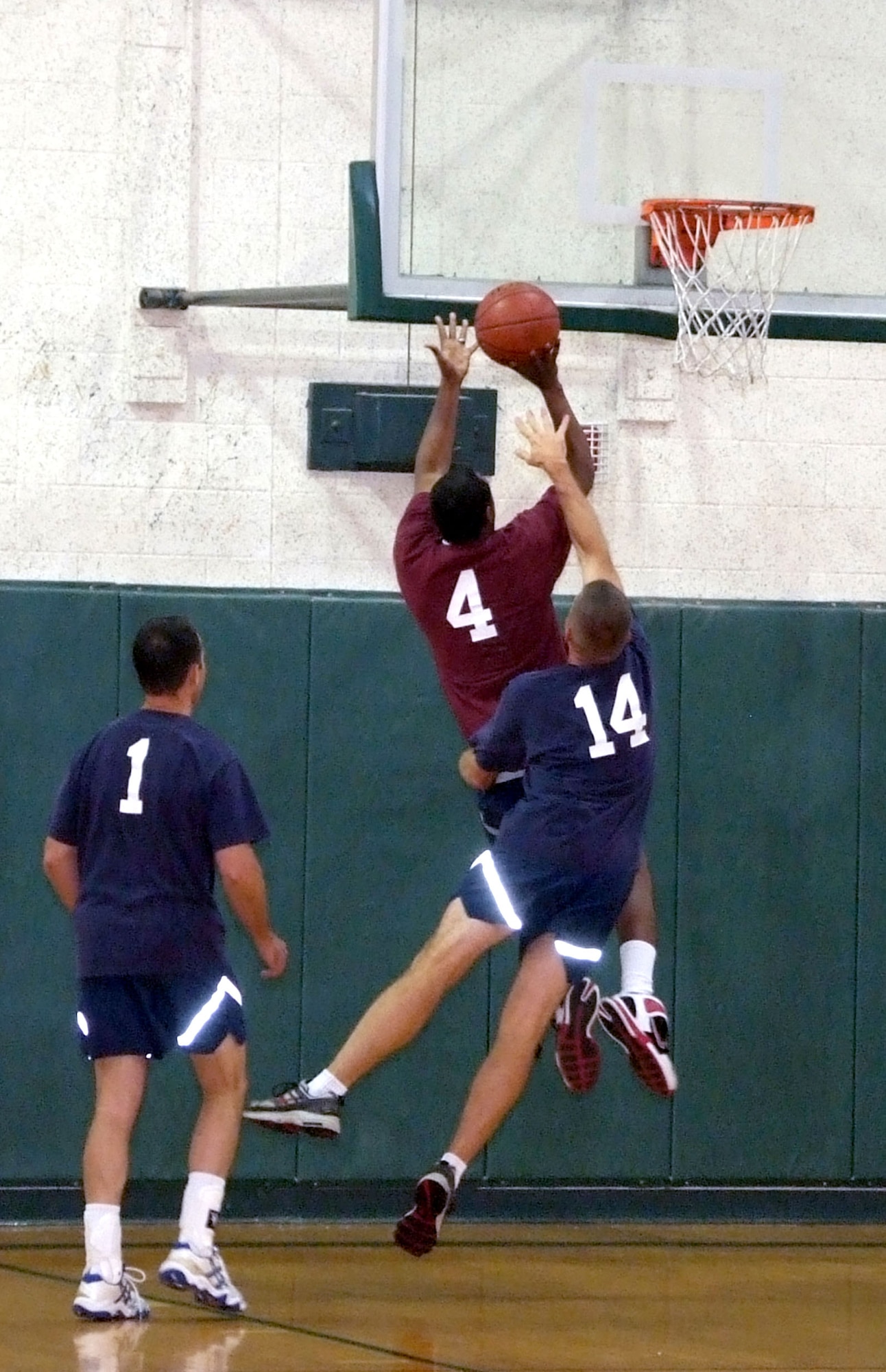 Lt. Col. Mark Batcho, 14, attempts to block Senior Airman Omar Robinson’s shot at the basket during the Commander’s Challenge basketball game held Wednesday, July 9, in the reopened Fitness Center gymnasium at Vance AFB, Okla. The gym now has a new air-conditioning system. The base-populous team scored a victory over the commanders, 44-38. (U.S. Air Force photo by Terry Wasson)