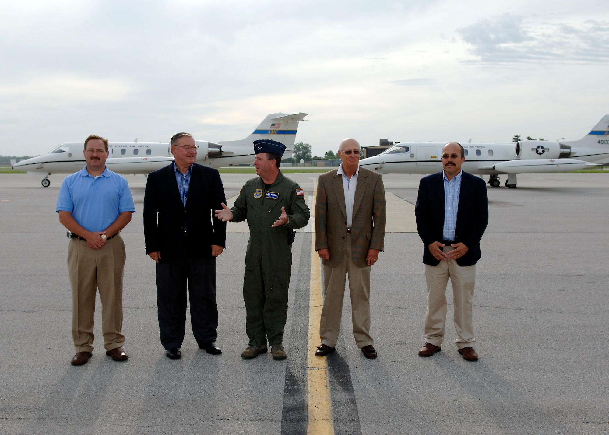 Six C-21 aircraft operated by the 458th Airlift Squadron were named in honor of the communities surrounding Scott Air Force Base last week.  The Aircraft were named the Spirits of Belleville, Swansea, Mascoutah, Lebanon, O'Fallon and Shiloh.  Mayors of the respective communities and other civic leaders attended plane naming ceremonies on Monday and Tuesday  to officially unveil the logos just to the right of the entrance to the planes. All of the visiting mayors expressed great excitement and gratitude for the honors their town received. 375th Airlift Wing commander Col. Al hunt explained the aircraft naming as great way for JTF Scott to show its gratitude for the support it receives from the surrounding communities. The logos on the planes will also be a great way for passengers and flight crews on the planes to start discussions about the continuing support. Pictured (left to right) Lebanon Mayor Scott Abner, Mascoutah Mayor Jerry Daugherty, 375th Airlift Wing commander Colonel Al Hunt, O'Fallon Mayor Gary Graham and Shiloh Mayor Jim Vernier on the flightline just before the official namings of their aircraft.
