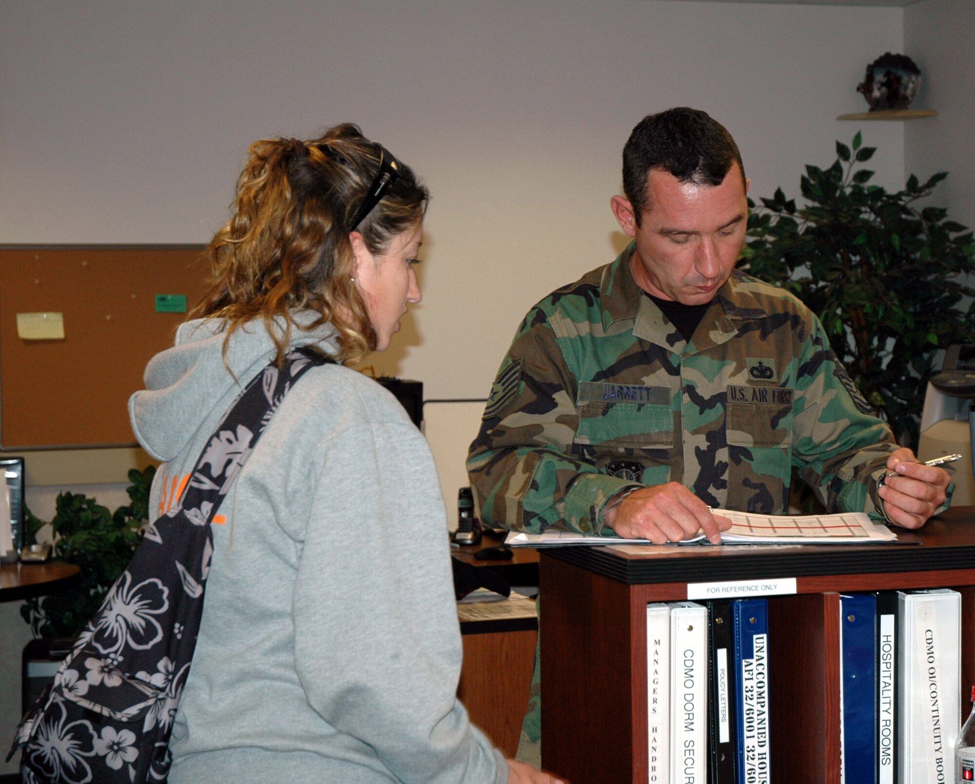 Tech. Sgt. Chirs Jarrett, a temporary dorm manager, sets up a room inspection for Airman 1st Class Danielle Goulet in the CDMO office in buidling 640 Monday. (U.S. Air Force photo/Valerie Mullett)