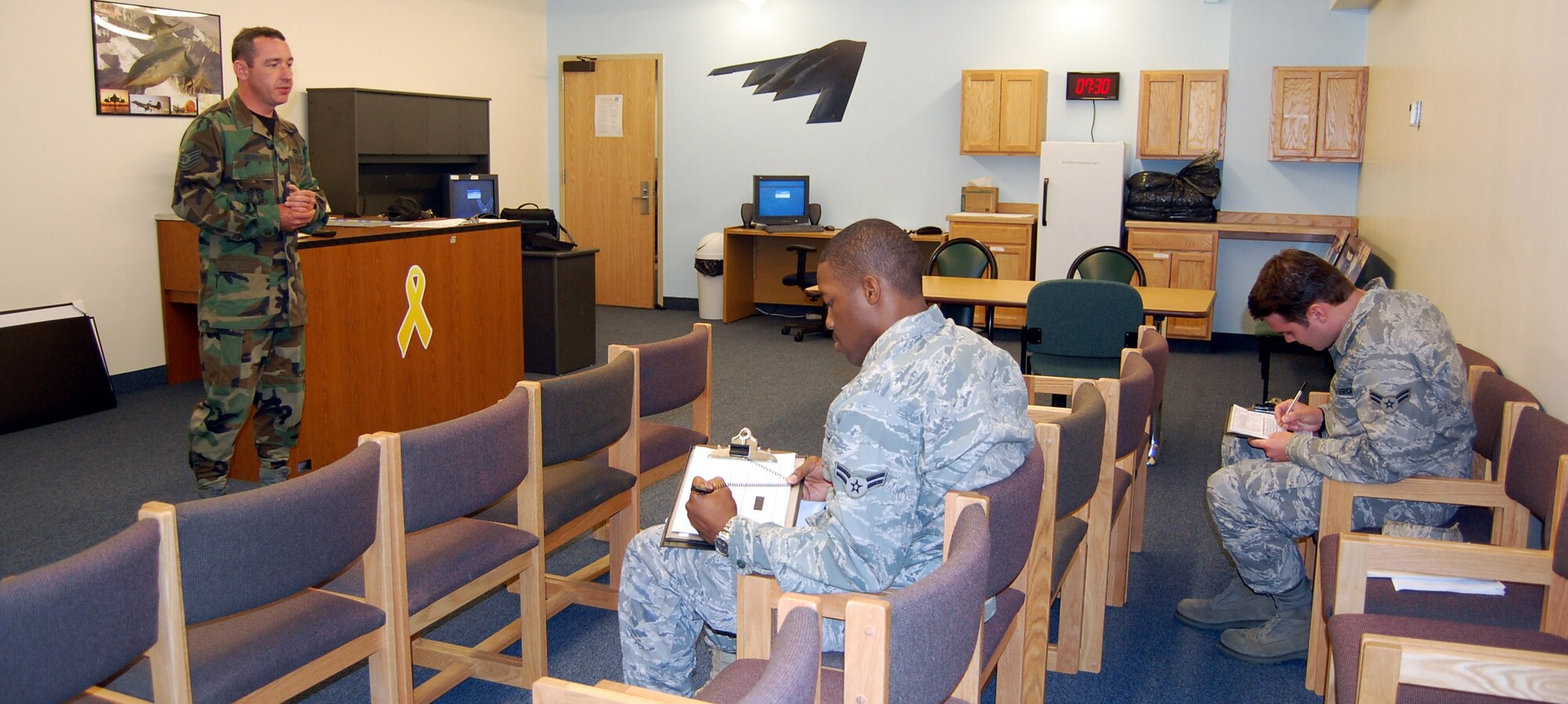 Tech. Sgt. Chris Jarrett inprocessed two new Airmen July 8. The in-processing includes a briefing that explains the rules and requirements of dormitory living. (U.S. Air Force photo/Airman 1st Class Emerald Ralston)