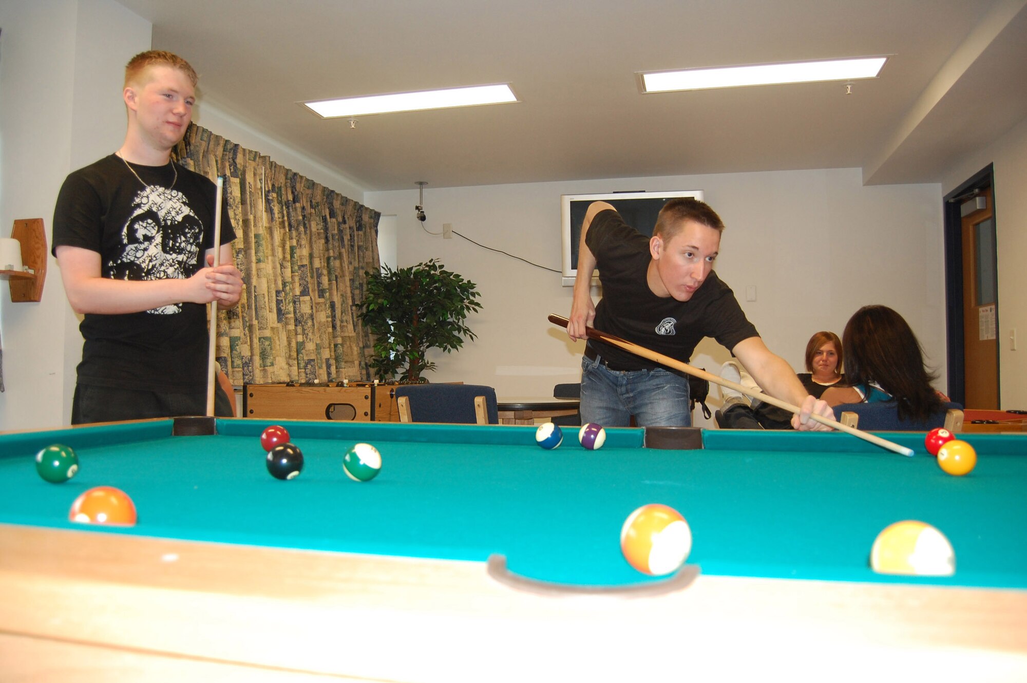 Dorm residents enjoy hanging out and shooting some pool in the day room. Each dorm has their own such area and some have been customized at the resident's recommendation. (U.S. Air Force photo/Airman 1st Class Emerald Ralston)