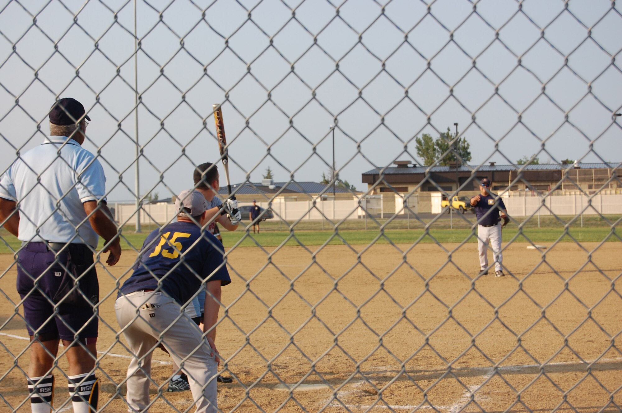 A member of Team FSS prepares to bat as a member of Team MMXS pitches during a softball game July 7. MMXS defeated FSS with a 17 to 2 win. (U.S. Air Force photo/Airman 1st Class Emerald Ralston)