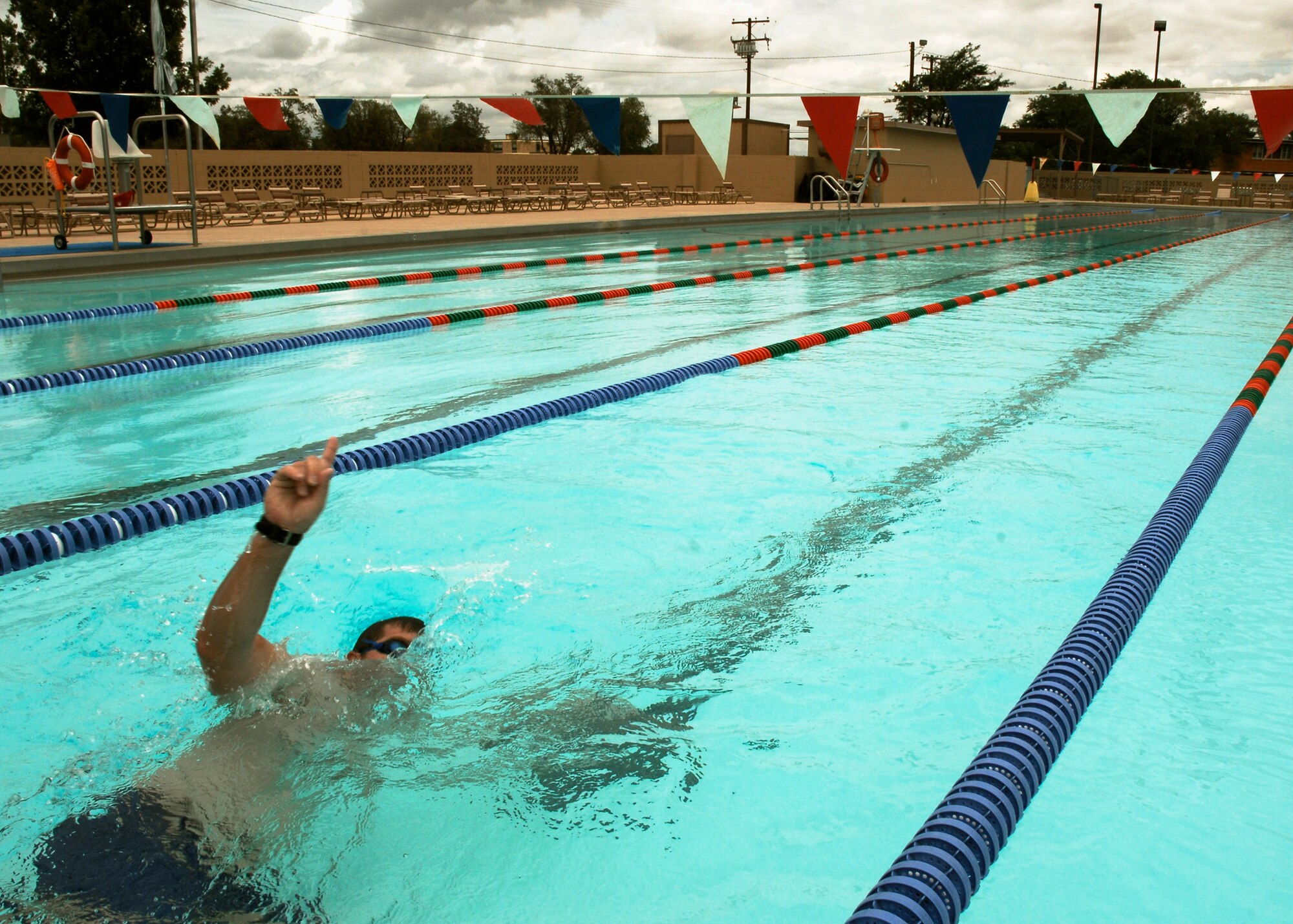 CANNON AIR FORCE, BASE, N.M. -- Capt. David Brandt, 73rd Special Operations Squadron, swims the final lap of 50 July 8. A fellow officer challenged the captain to a 5,000-meter swim in support of the squadron's support of the Habitat For Humanity Charity foundation. (U.S. Air Force photo by Airman 1st Class Evelyn Chavez )
