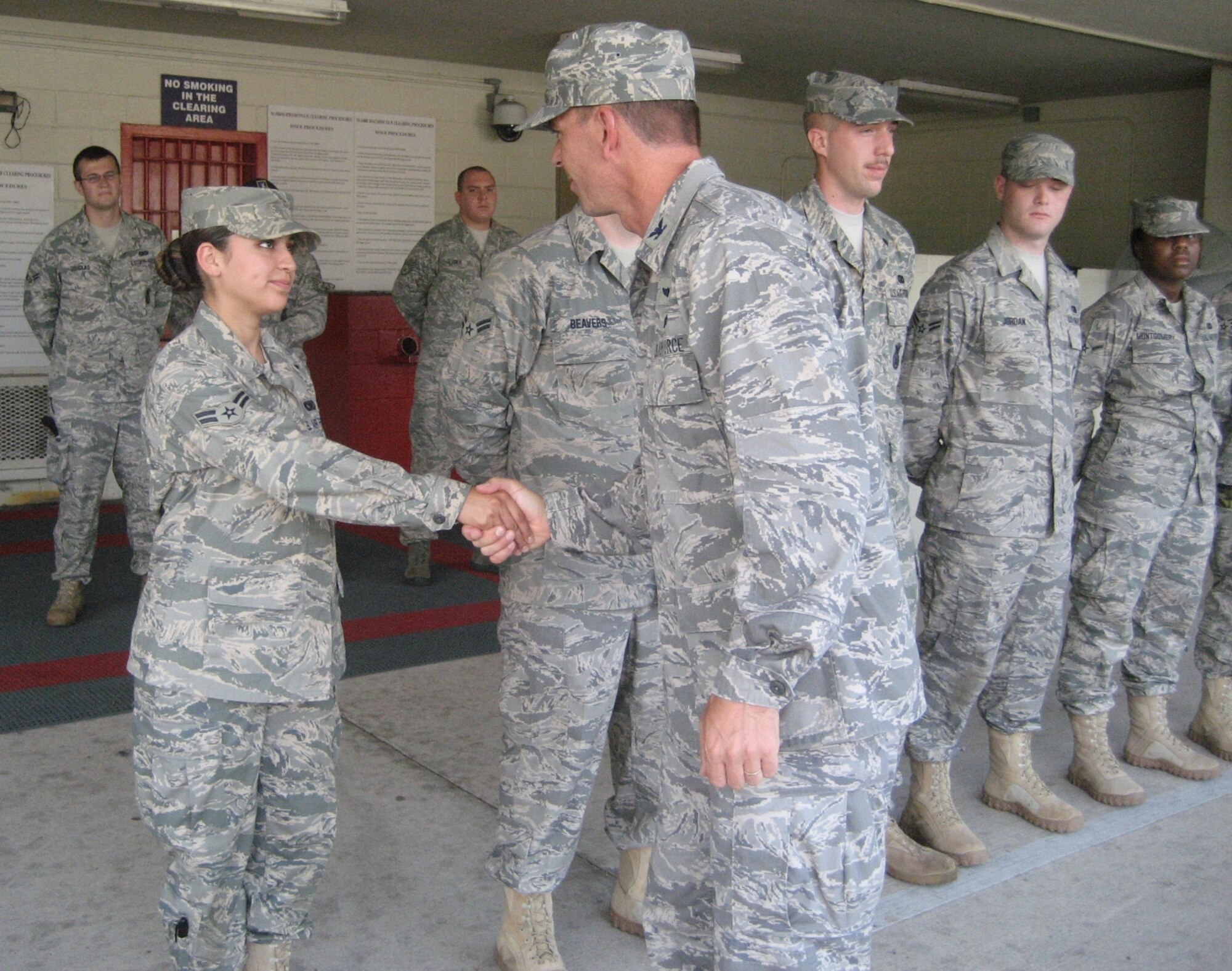 Col. Bruce McClintock, 96th Air Base Wing commander, shakes hands with Airman 1st Class Analissa Anguiano, at the 96th Security Forces Squadron Saturday before she and five other security forces personnel leave base for deployment. All six Airmen volunteered to serve a year on a military police squad that will train Iraqi districts outside the wire. They will first attend an advanced training course in their career field at Ft. Dix, N.J, for two months. Airman Anguiano has also recently been selected for  a new rank of Senior Airman, below the zone. (U.S. Air Force photo by Chief MSgt. Troy Engholm)