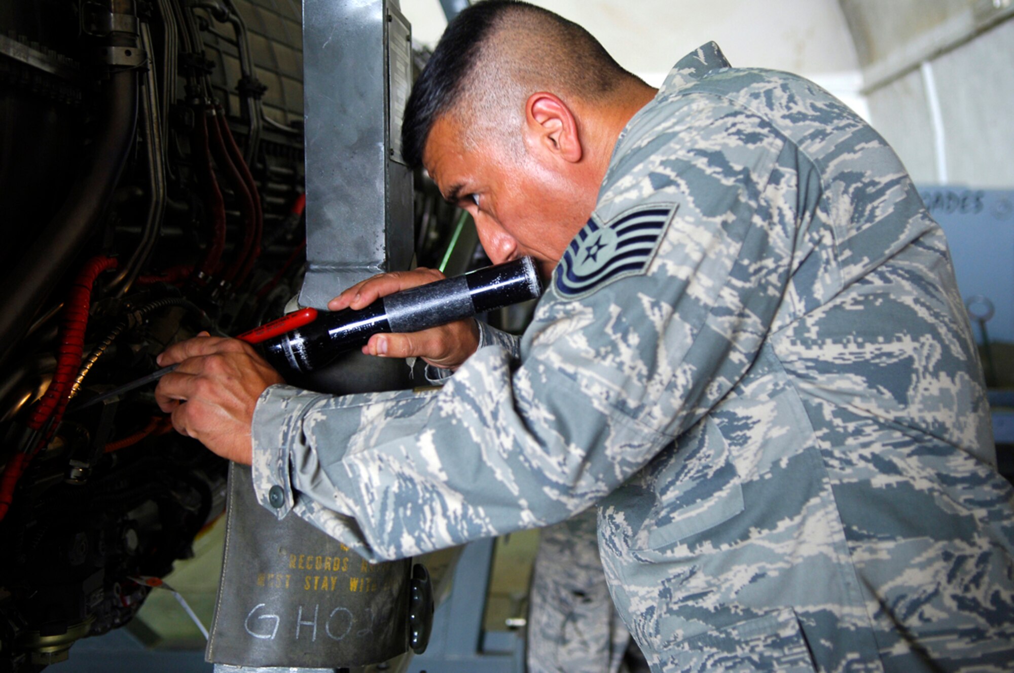 JOINT BASE BALAD, Iraq -- Tech. Sgt. Juan Ramon, a 332nd Expeditionary Maintenance Squadron engine mechanic, performs a pre-installation inspection on a GE F110-100 jet engine here July 7. The engines are downloaded from the aircraft on a regular basis to check for any wear and tear on the components. Sergeant Ramon is deployed from the New York Air National Guard. (U.S. Air Force photo/Staff Sgt. Mareshah Haynes)