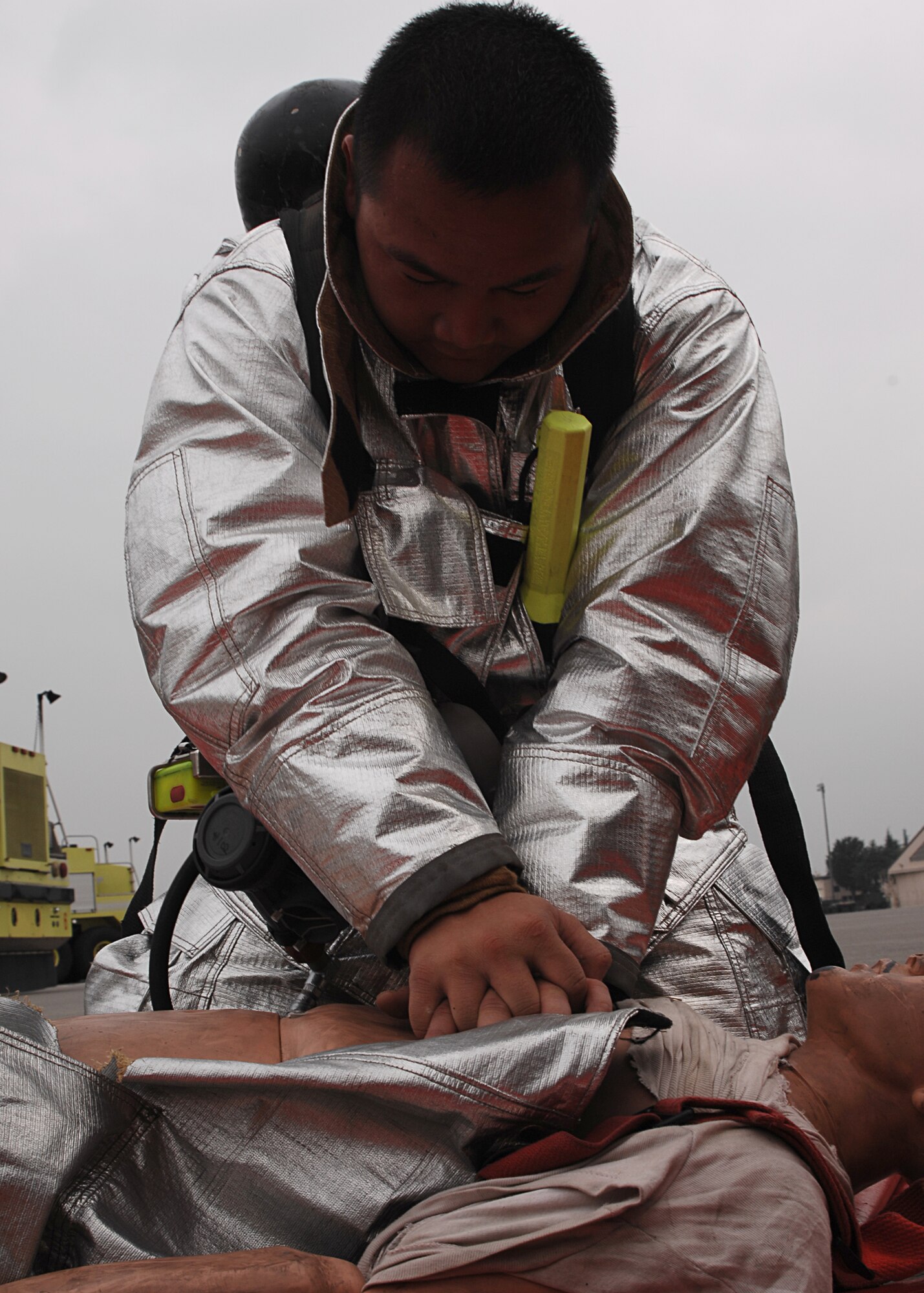 YOKOTA AIR BASE, Japan - Airman 1st Class Kevin Sovvannkhan, from the 374th Civil Engineer Squadron, performs CPR on a simulated burn victim while responding to a C-130 fire exercise during Exercise Beverly Morning 08-07 on July 10. The exercise is designed to test base deployment and operational readiness. (U.S. Air Force photo by Airman 1st Class Jonathan Fowler)