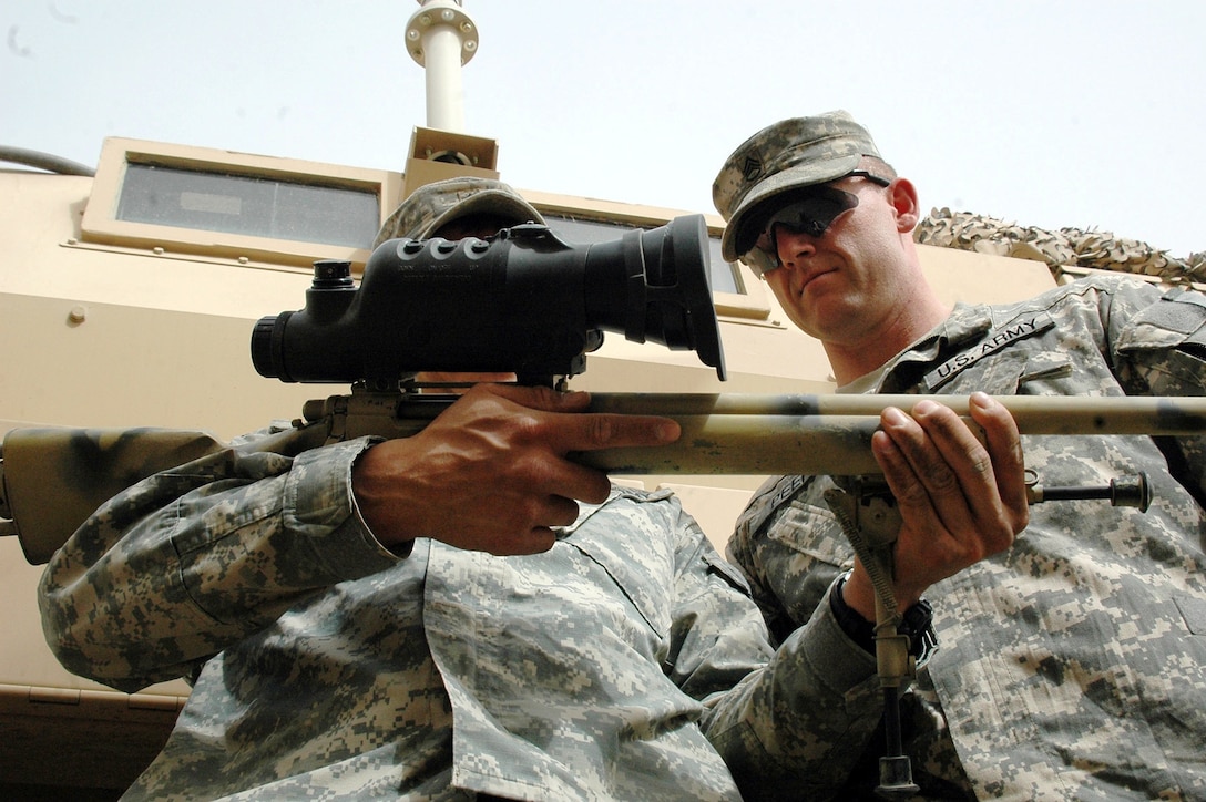 Army Sgt. Murray Spence (left), an infantry scout sniper originally from Canada, reads the serial number of his M-24 sniper rifle as Army Staff Sgt. Tommy Peek, Spence’s platoon sergeant from Fort Polk, La., verifies the number during an inventory at Forward Operating Base Loyalty, Iraq, July 8, 2008. Both soldiers are assigned to Multinational Division Baghdad with Scout Platoon, Headquarters and Headquarters Company, 2nd Battalion, 30th Infantry, 4th Brigade Combat Team, 10th Mountain Division. U.S. Army photo by Staff Sgt. Matt Meadows, Multinational Division Baghdad