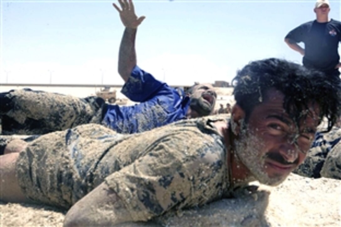 A member of the Iraqi Special Weapons and Tactics team calls for help to U.S. Navy instructors while participating in exercises with members of his team at Lake Quadsiyah in Haditha, Iraq, July 7, 2008. 