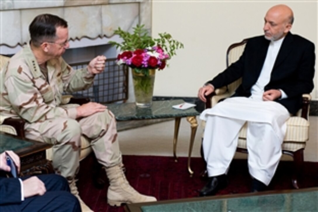 U.S. Navy Adm. Mike Mullen, chairman of the Joint Chiefs of Staff, talks with Afghan President Hamid Karzai, Kabul, Afghanistan, July 10, 2008. Mullen is on a six-day tour of the region to visit troops and host a USO contingent.