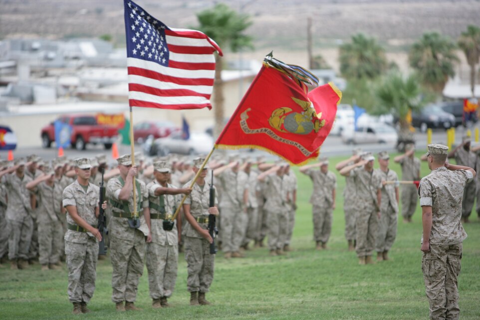 Lt. Col. James R. Parrington, out-going commanding officer, renders honors during the playing of the national anthem.