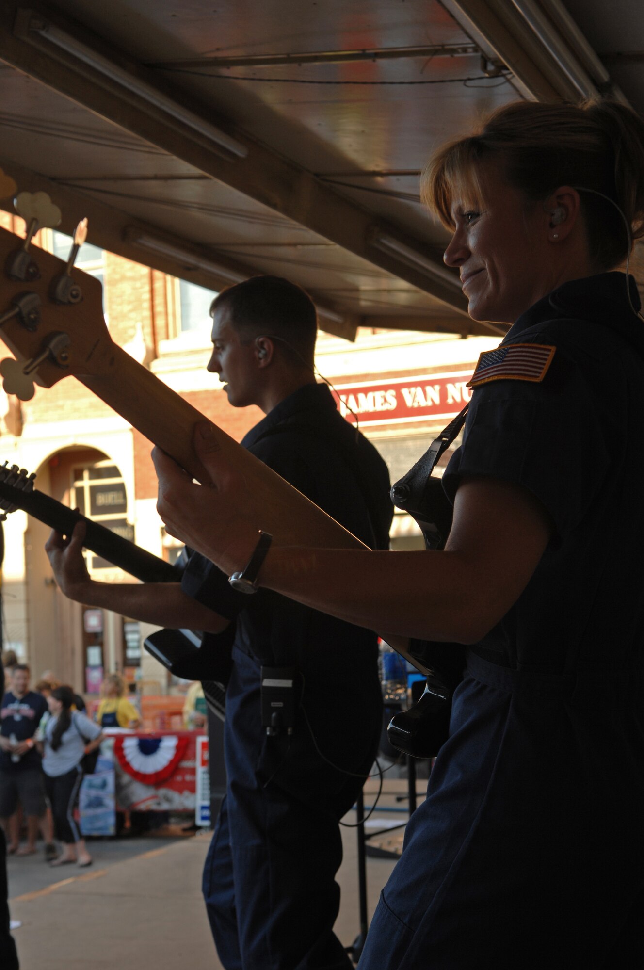 (Front) Master Sgt. Lori Weber, Night Wing bass guitarist, and (back) Staff Sgt. Clint Whitney, Night Wing guirtarist, entertain the crowd by performing various songs on 7th Street in Rapid City, S.D., July 10. Night Wing is part of the Heartland of America Band from Offutt Air Force Base, Neb. (US Air Force photo/Airman Corey Hook)